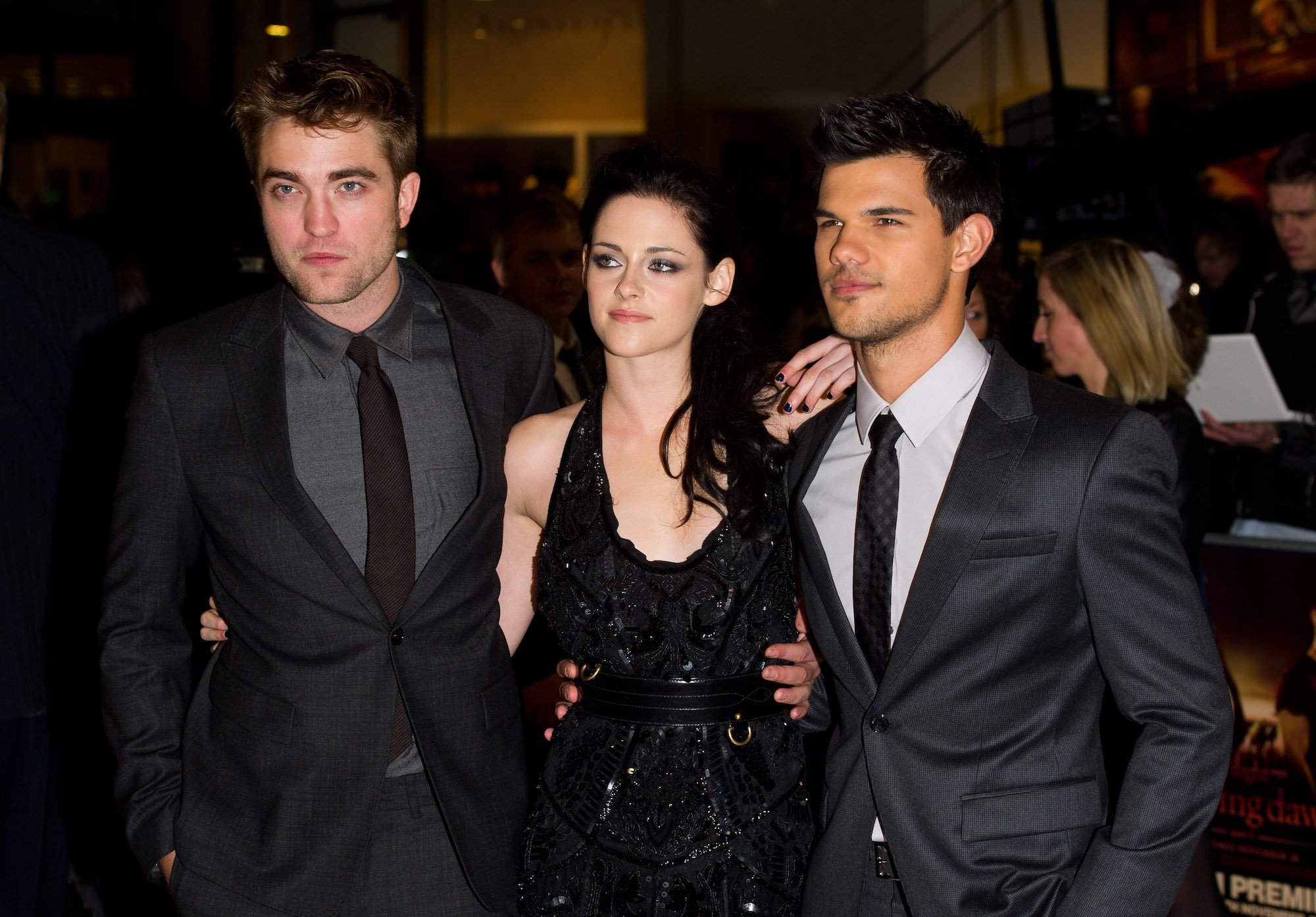 (L-R) Robert Pattinson, Kristen Stewart and Taylor Lautner smiling