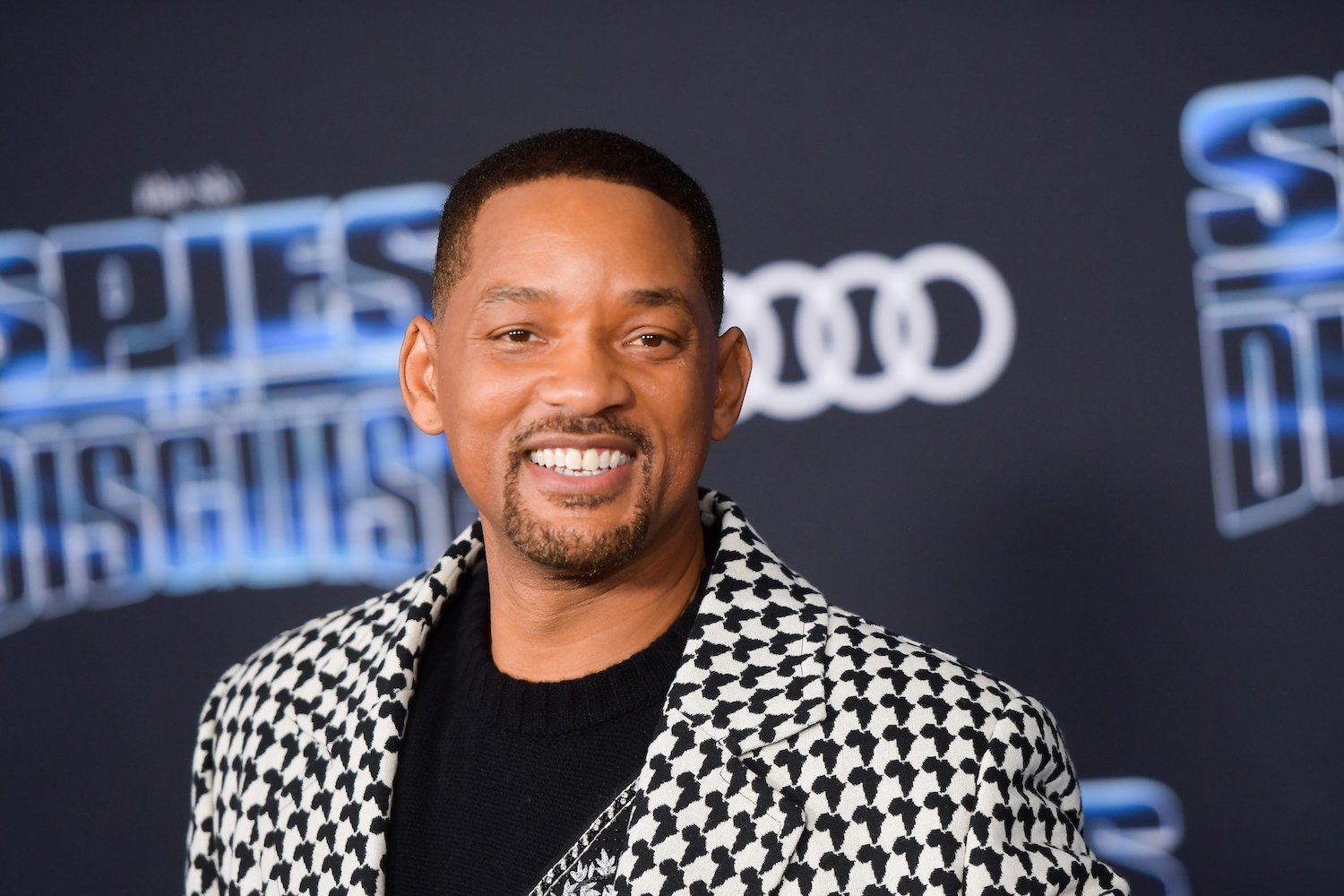 Will Smith smiling in front of a black background