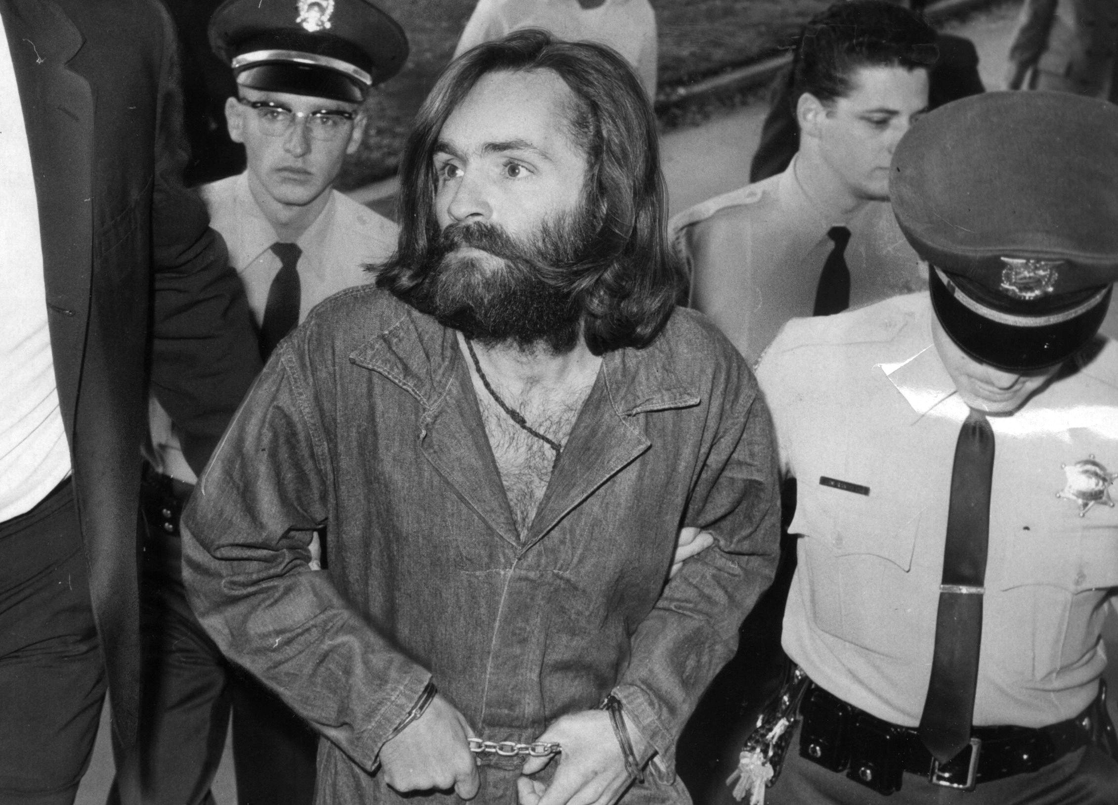 Charles Manson with police officers