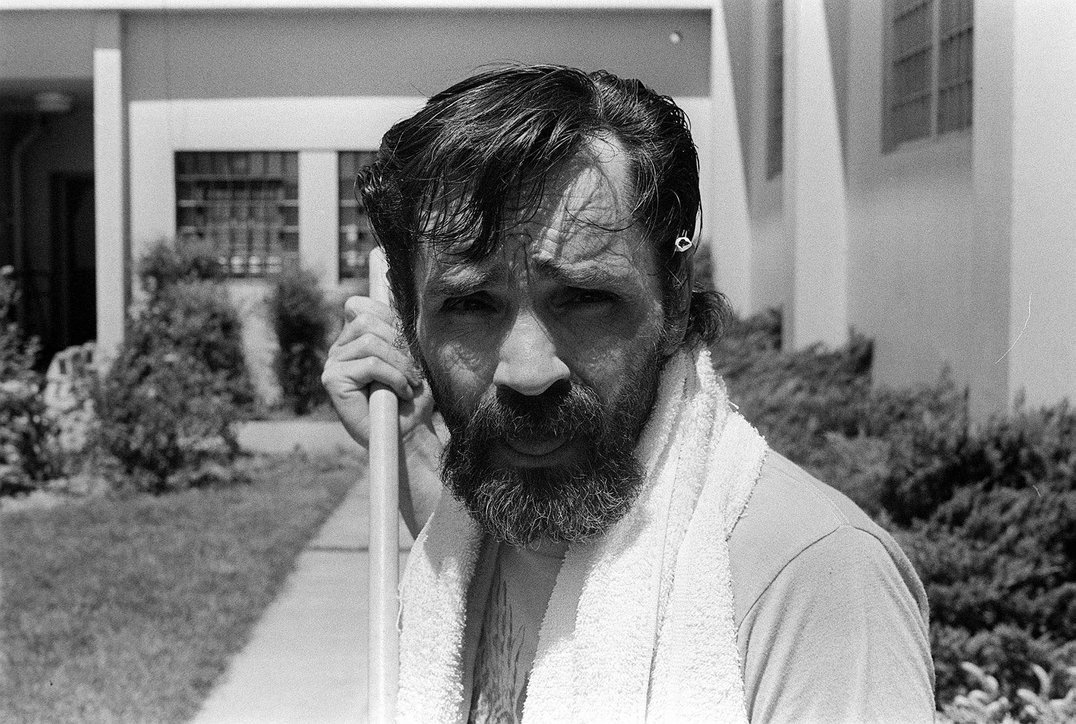 Charles Manson in front of a building