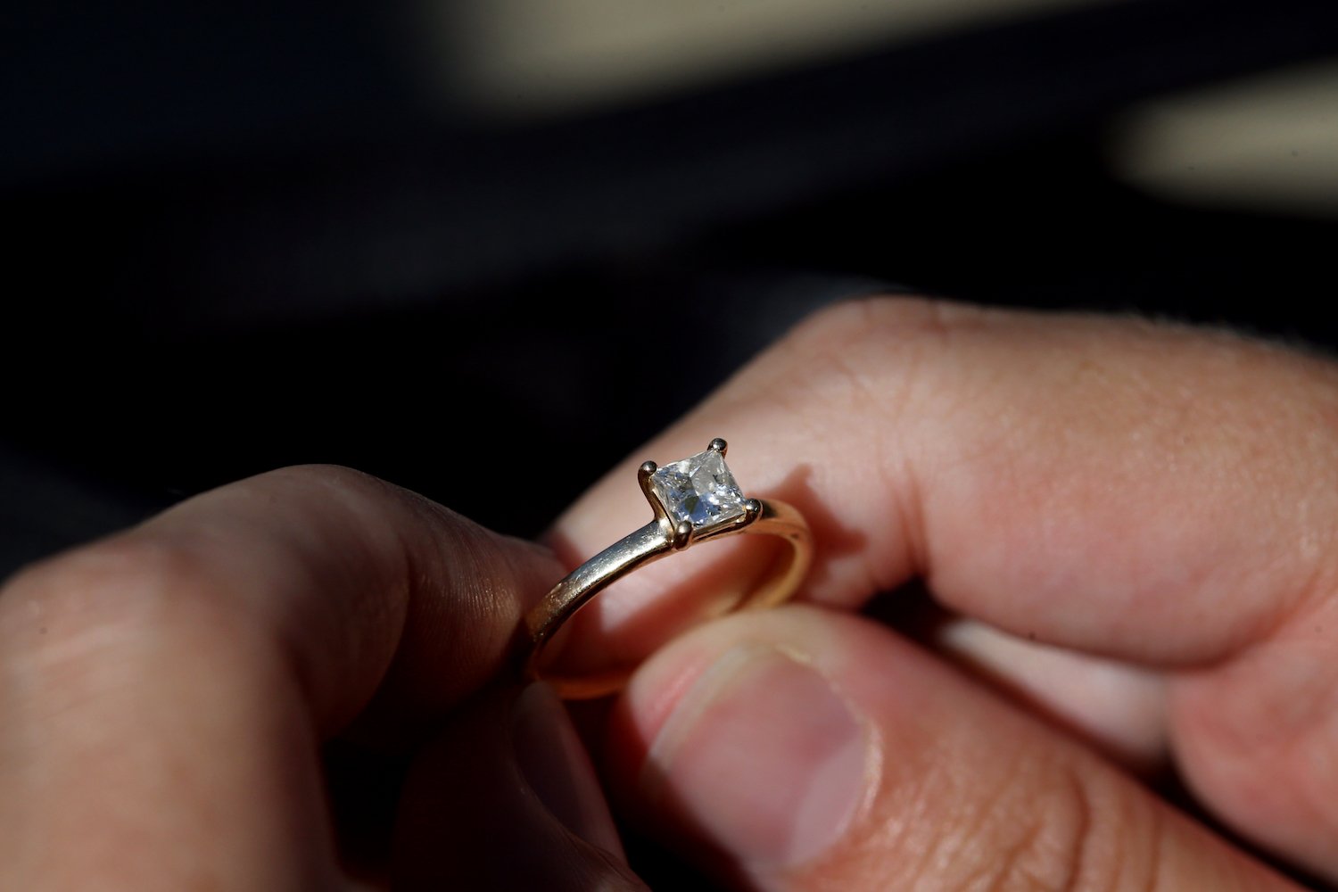 hands holding an engagement ring