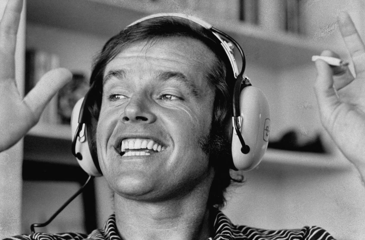 Actor Jack Nicholson enjoying Rock music via earphones, at his home