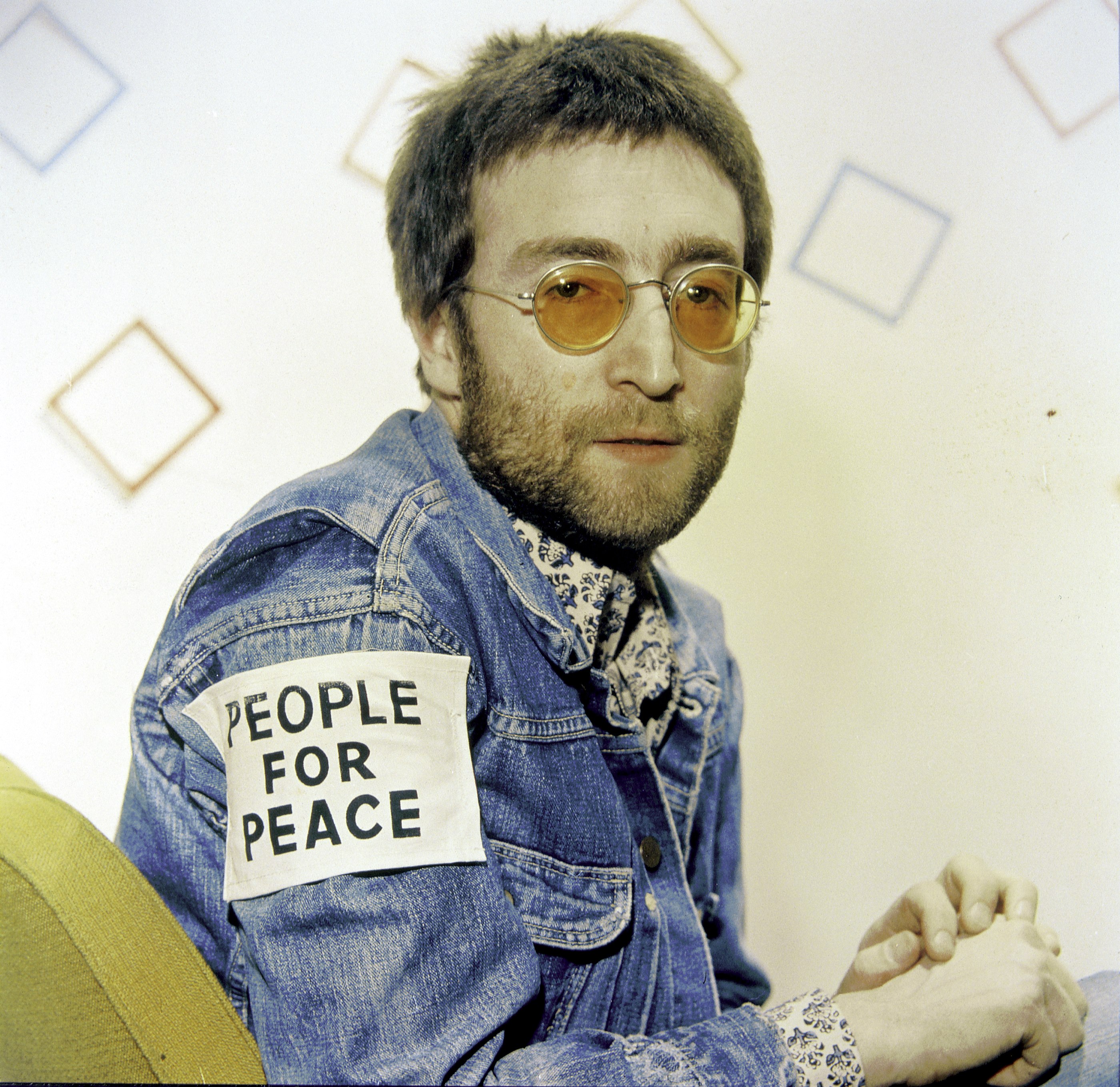 John Lennon wearing a patch that says "People for Peace"