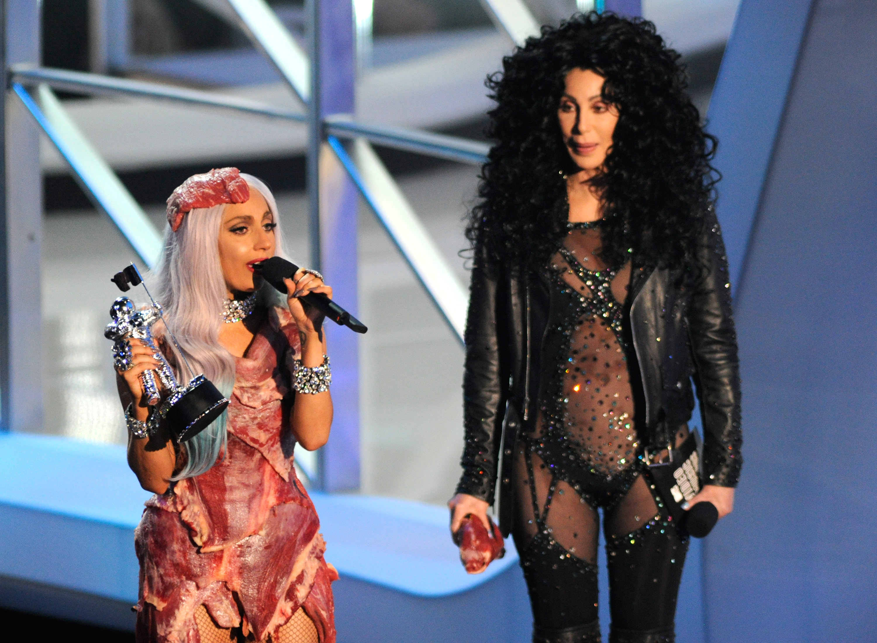 Lady Gaga in a meat dress next to Cher