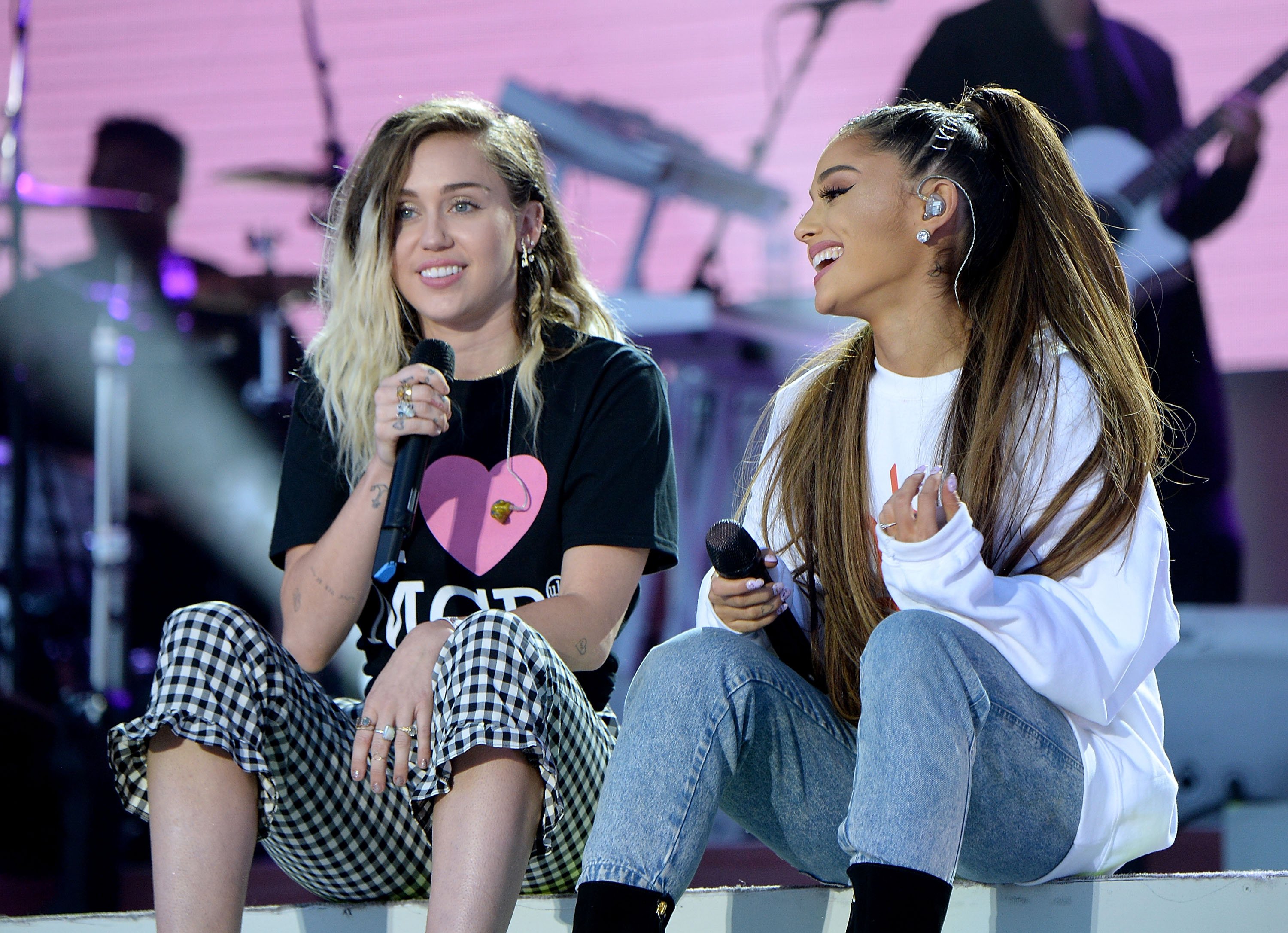 Ariana Grande (R) and Miley Cyrus perform on stage during the One Love Manchester Benefit Concert on June 4, 2017, in Manchester, England.