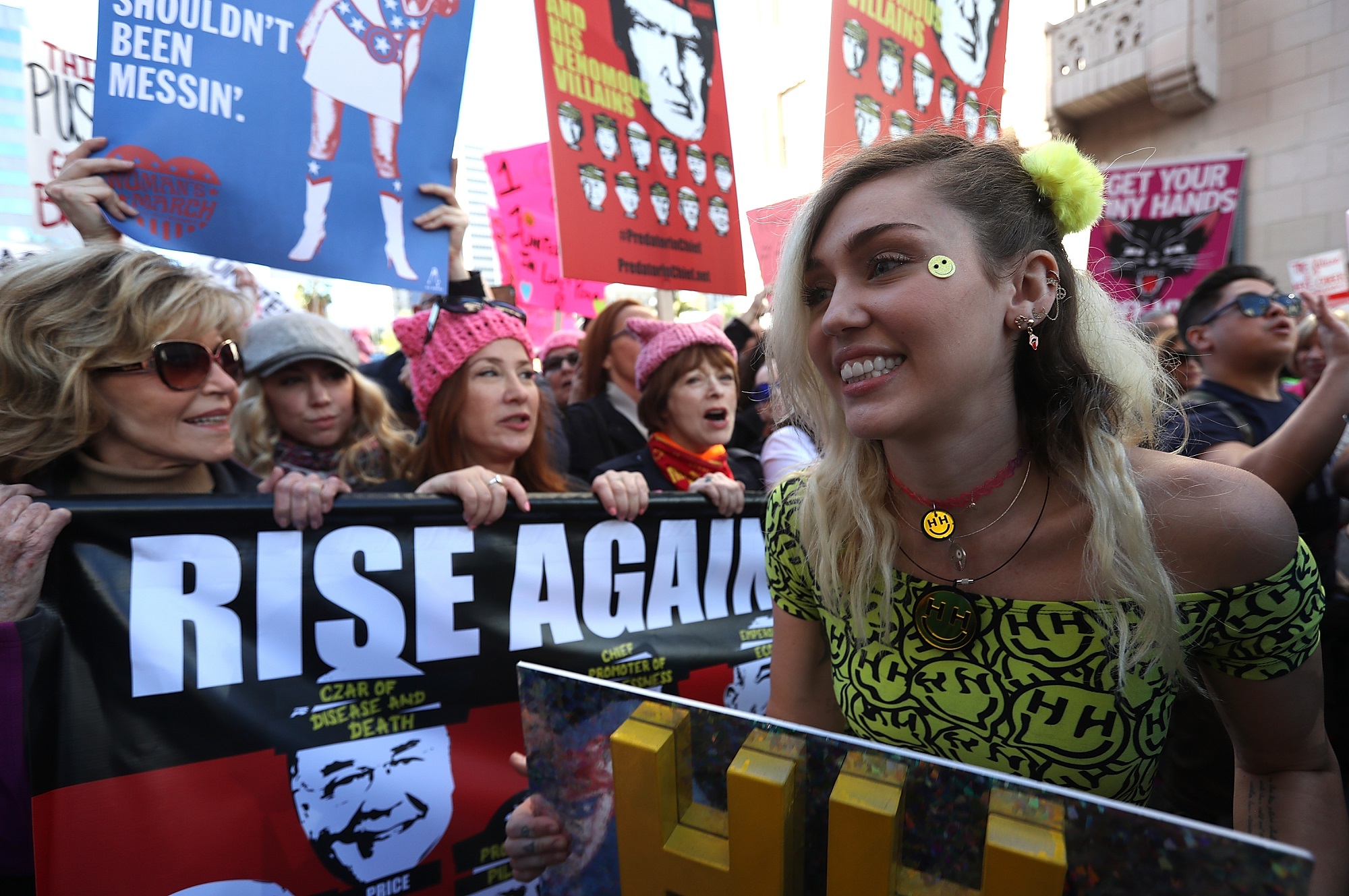 Miley Cyrus (R) marches during the Women's March on January 21, 2017, in Los Angeles, California.  Tens of thousands of people took to the streets of Downtown Los Angeles for the Women's March in protest after the inauguration of President Donald Trump.