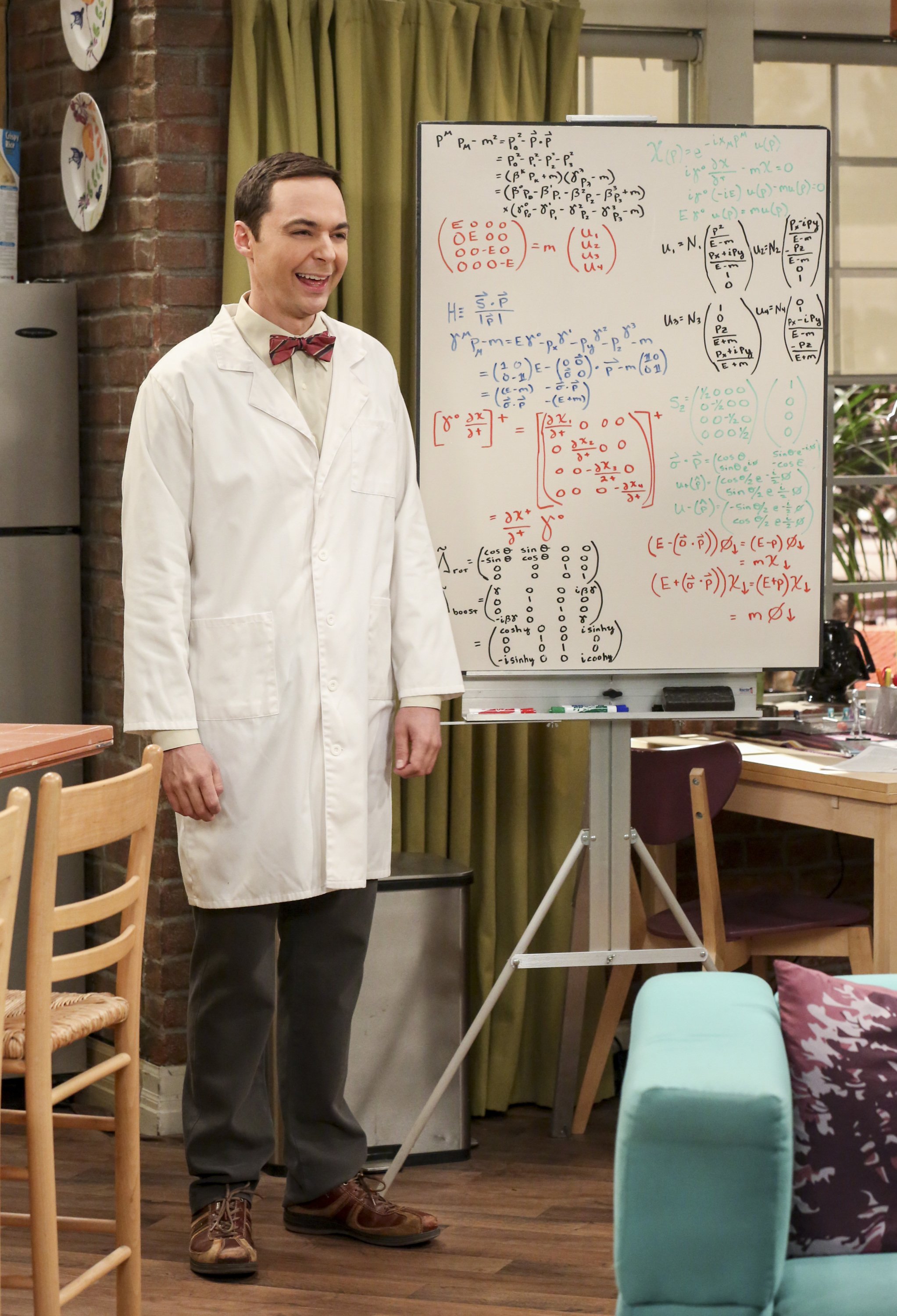 Jim Parsons as Sheldon Cooper stands next to his whiteboard