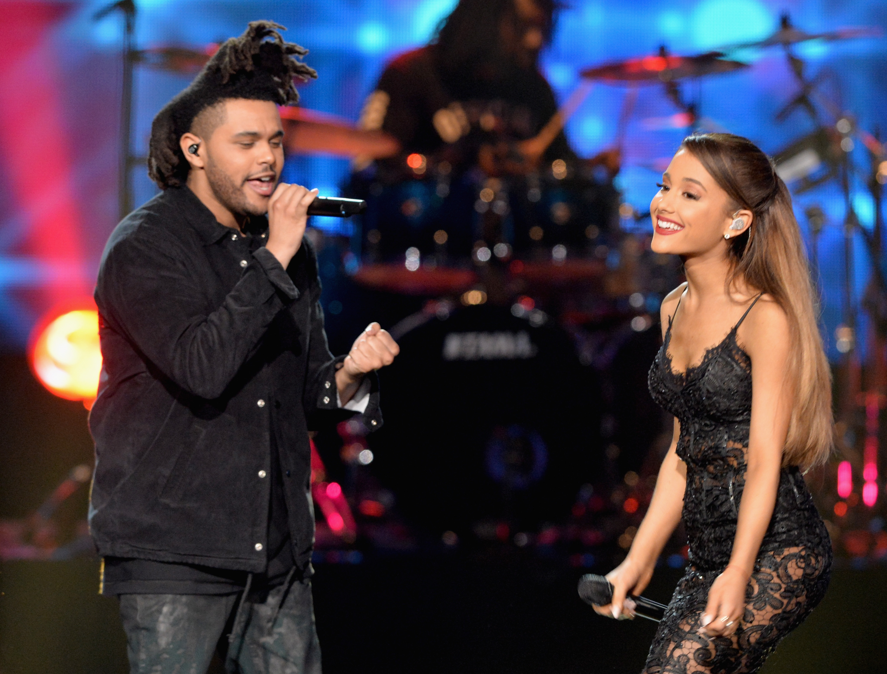 The Weeknd (L) and Ariana Grande perform onstage at the 2014 American Music Awards on November 23, 2014, in Los Angeles, California.