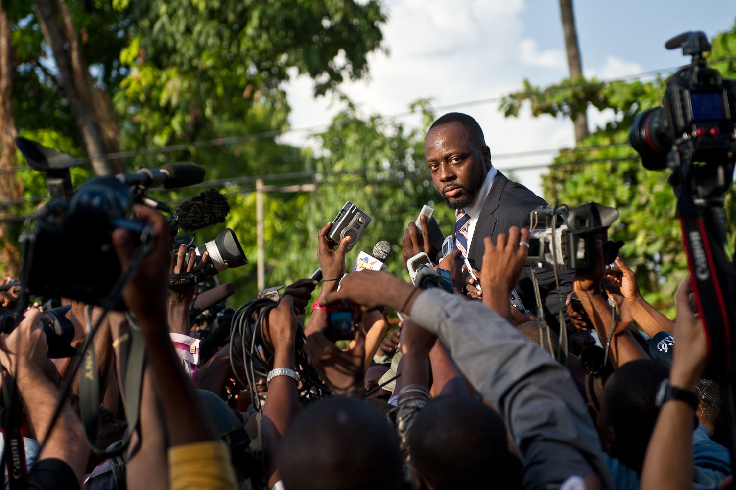 Wyclef Jean near reporters