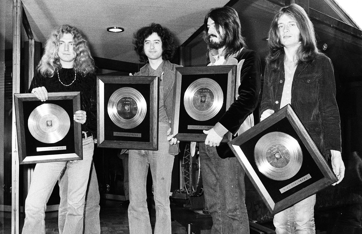 Led Zeppelin holding gold records