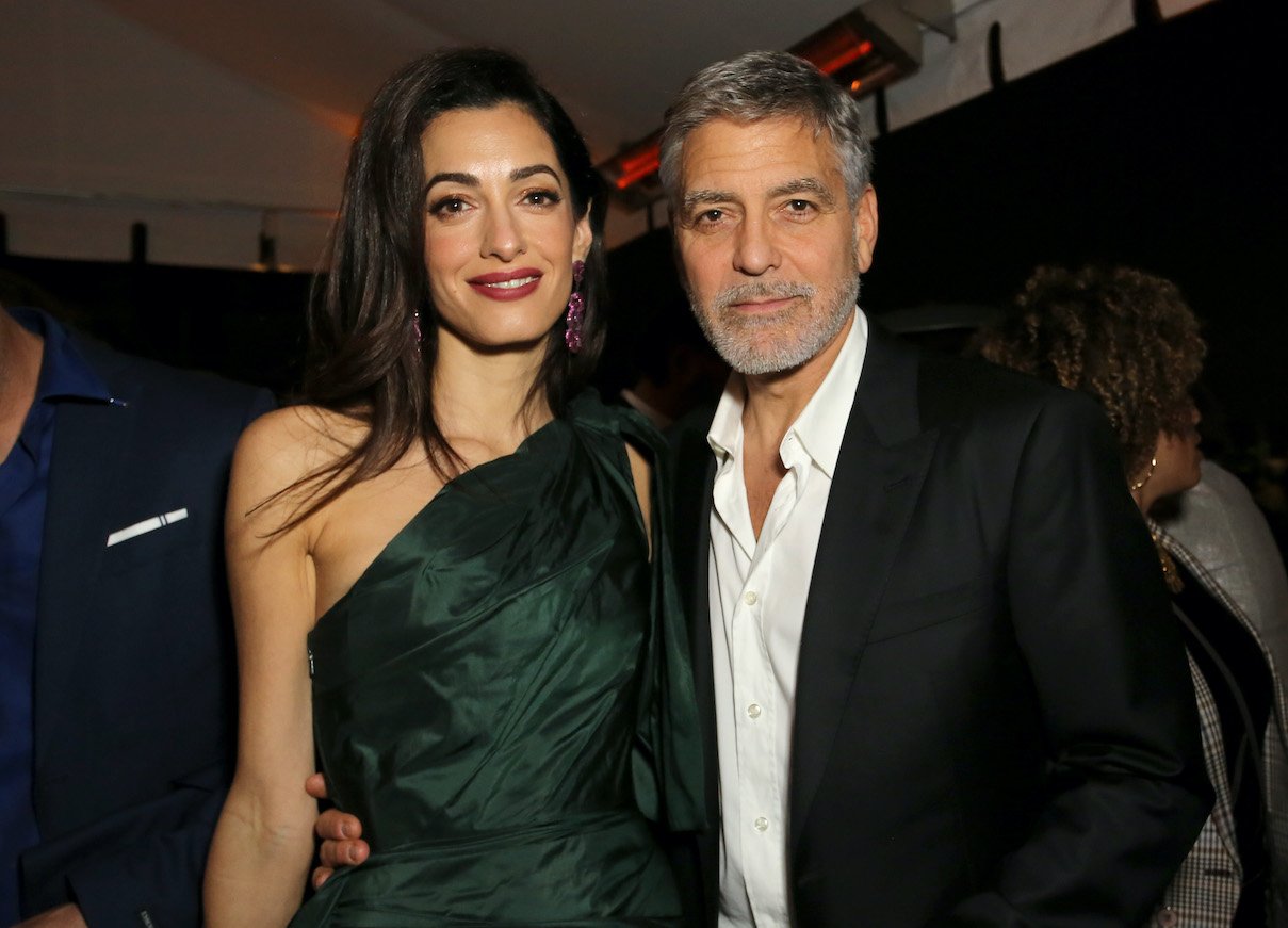 Amal Clooney and George Clooney pose together attend the premiere of Hulu's 'Catch-22'