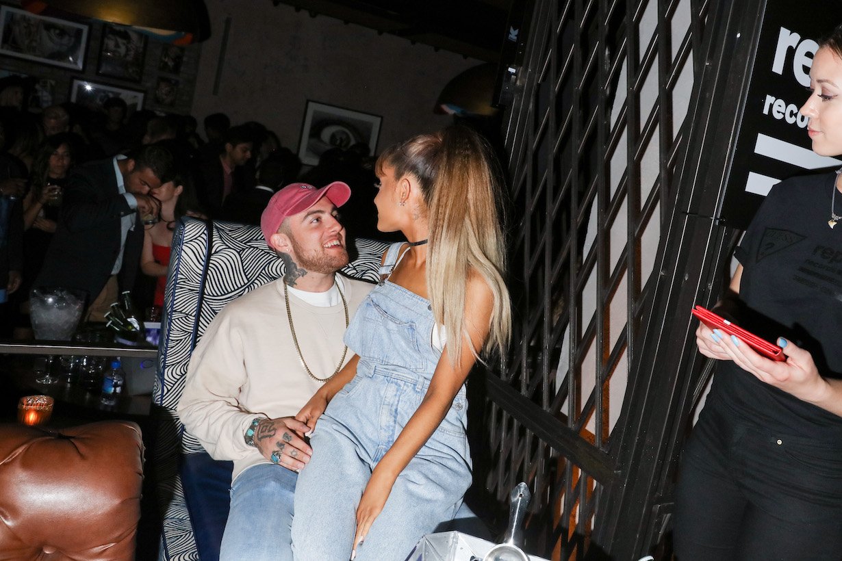 Ariana Grande sitting on Mac Miller's lap at the Republic Records 2016 VMA afterparty in 2016
