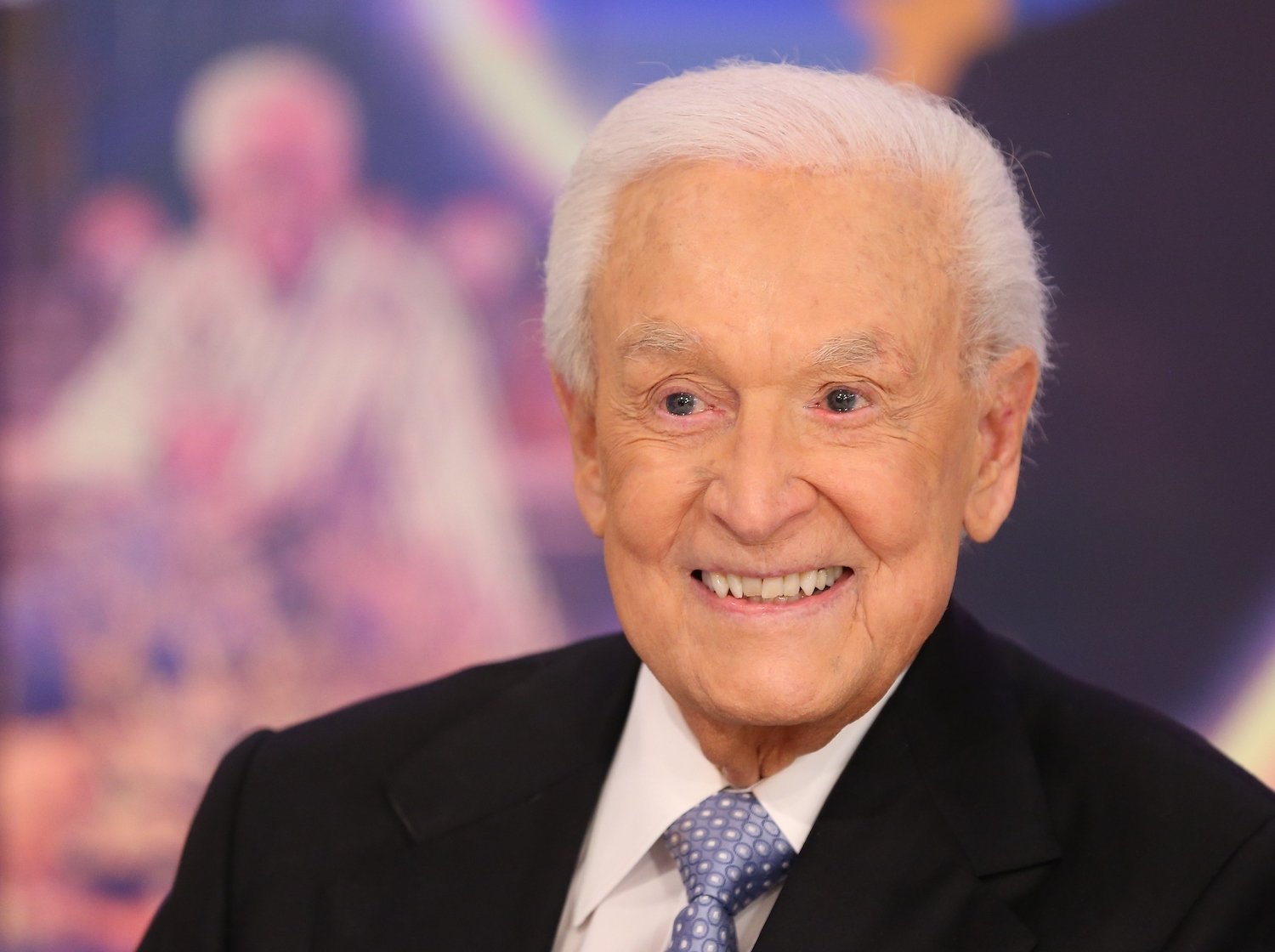 Bob Barker smiling in front of a blurred background