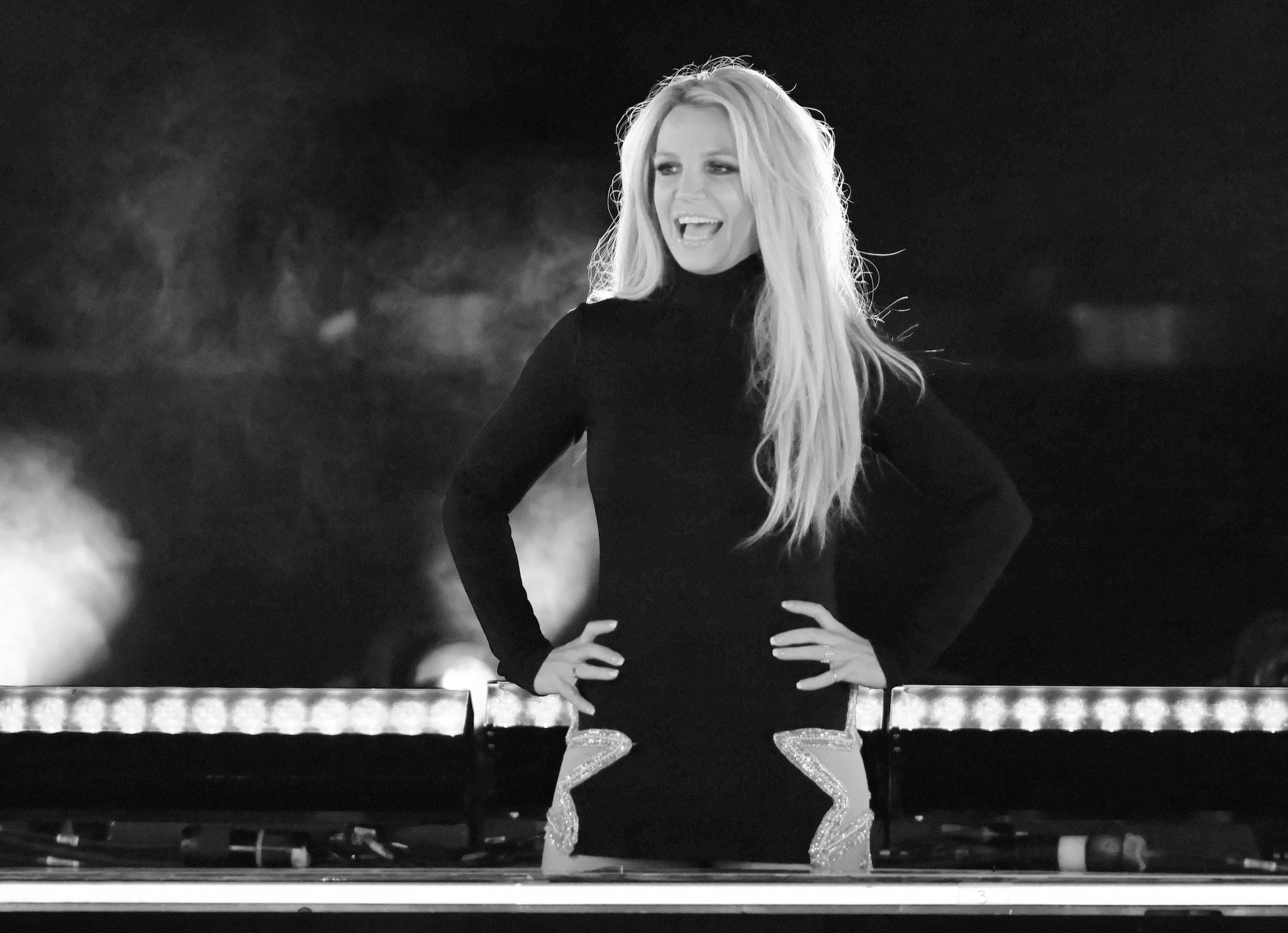 Britney Spears smiling on stage, in black and white