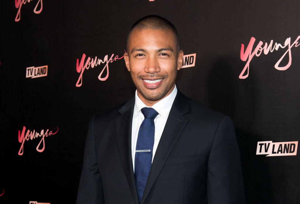Charles Michael Davis smiling in front of a black background