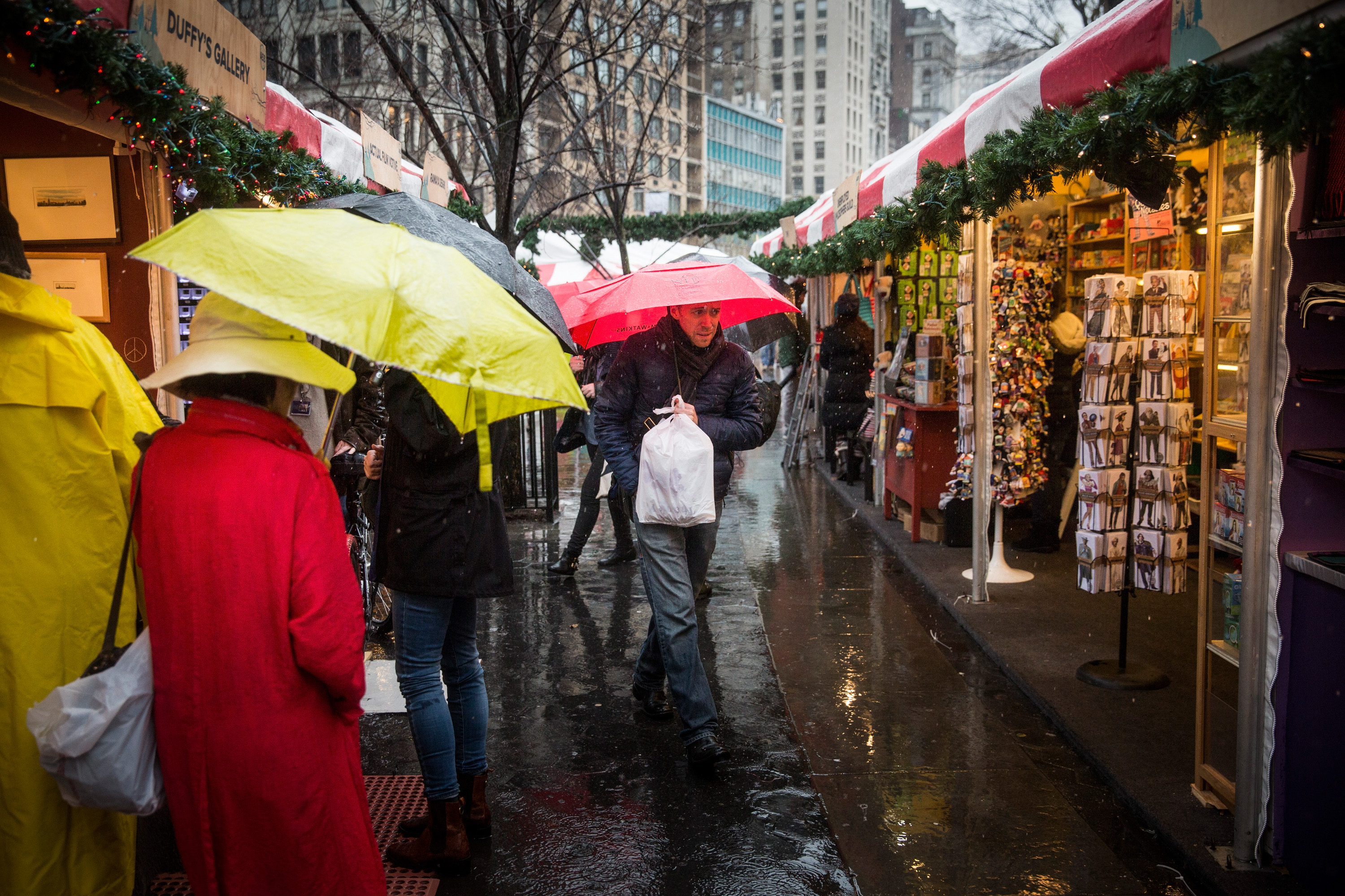 Union Square's open-air holiday market in the rain on Christmas Eve