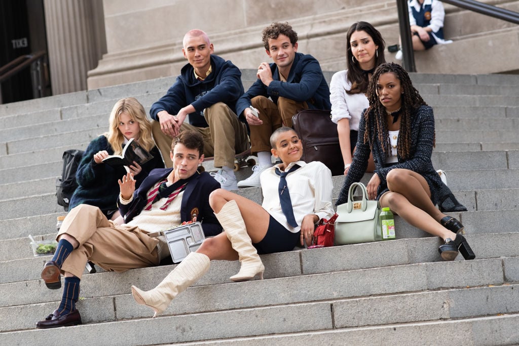 Evan Mock, Eli Brown, Zión Moreno, Emily Alyn Lind, Thomas Doherty, Jordan Alexander and Savannah Lee Smith sitting on the steps of the Metropolitan Museum of Art