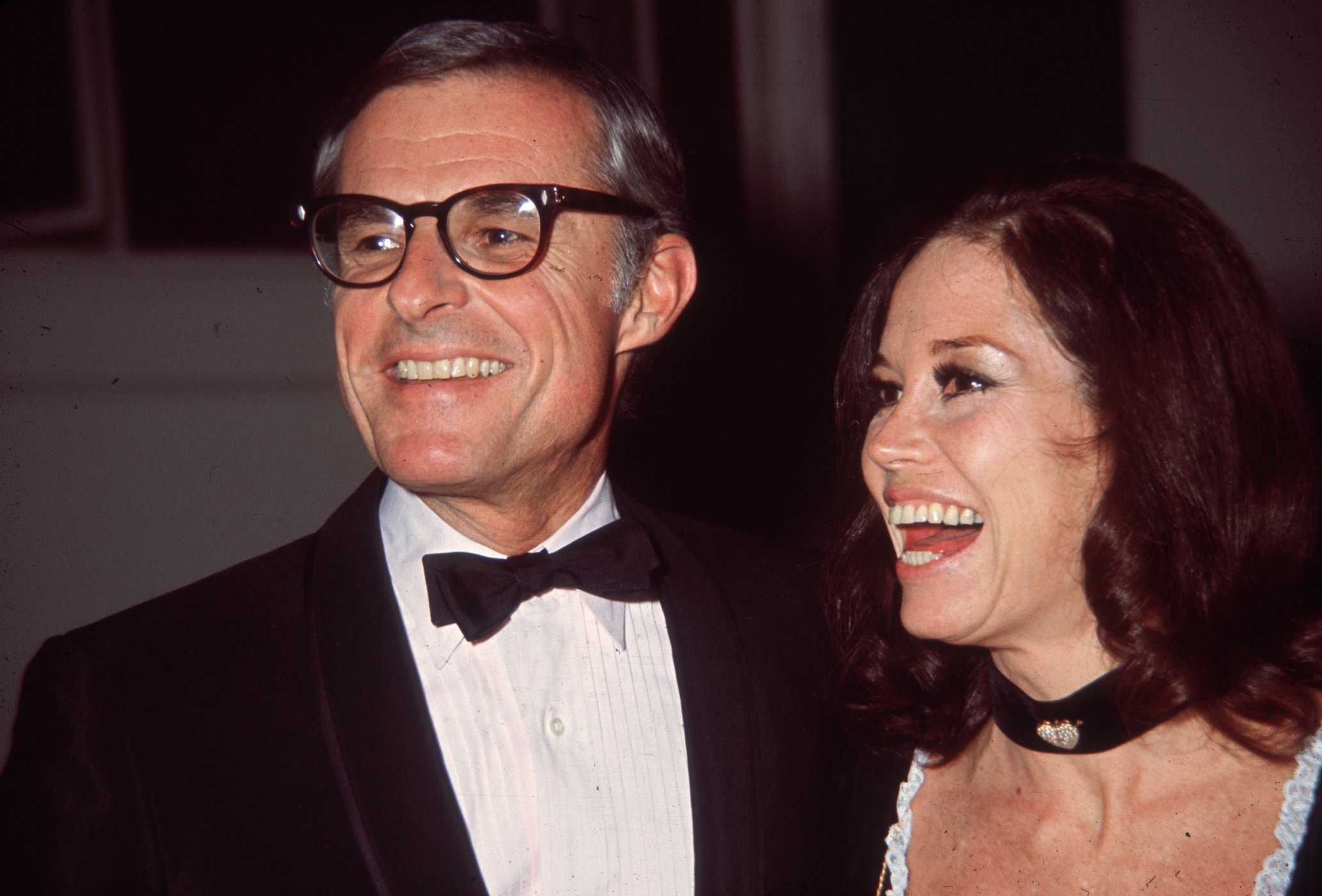 Mary Tyler Moore smiling as she stands next to her husband, Grant Tinker