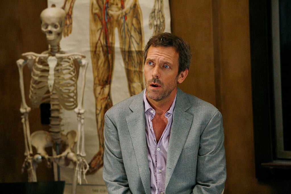 Hugh Laurie as Dr. Greg House, looking to the side