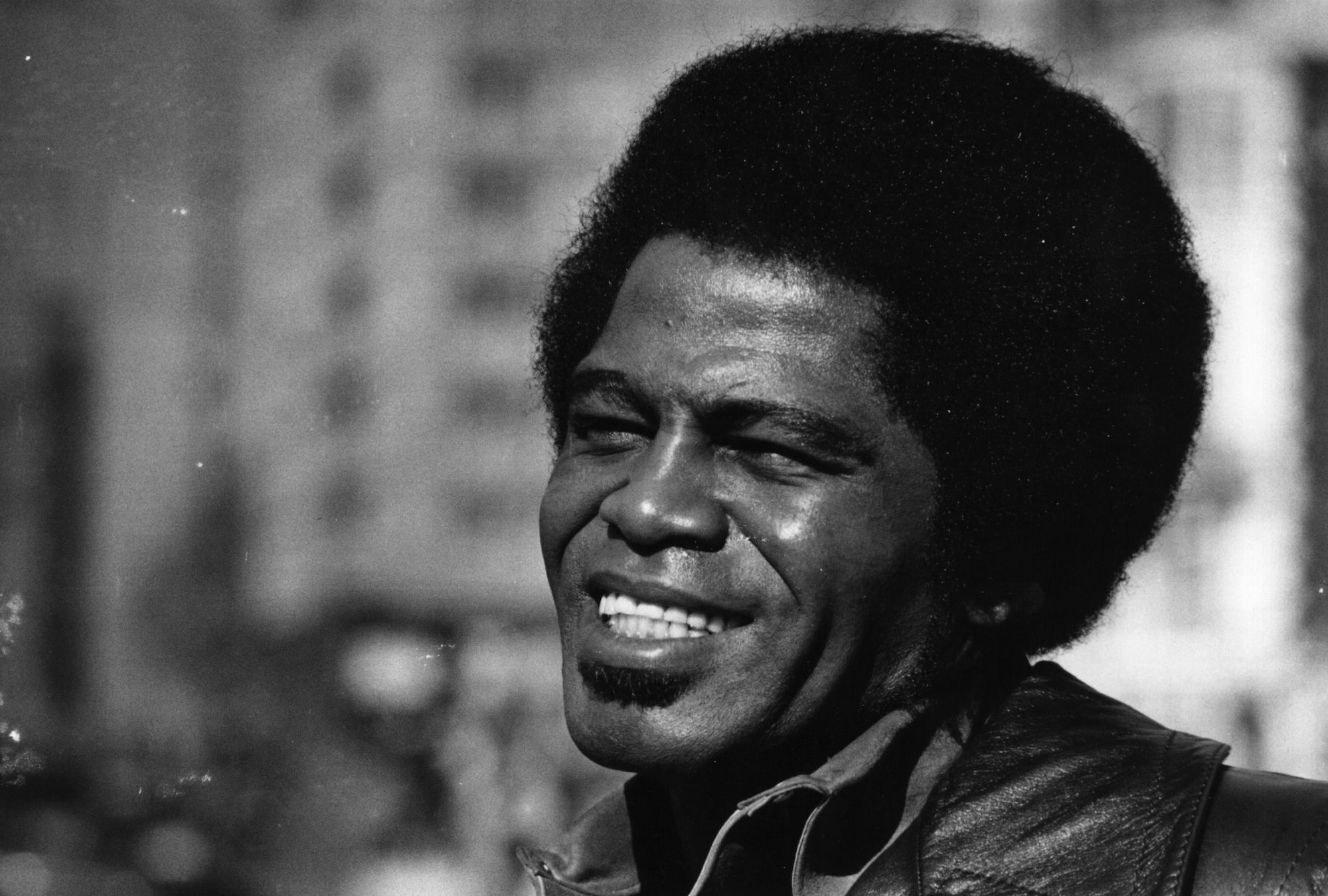 James Brown smiling in a black and white photo