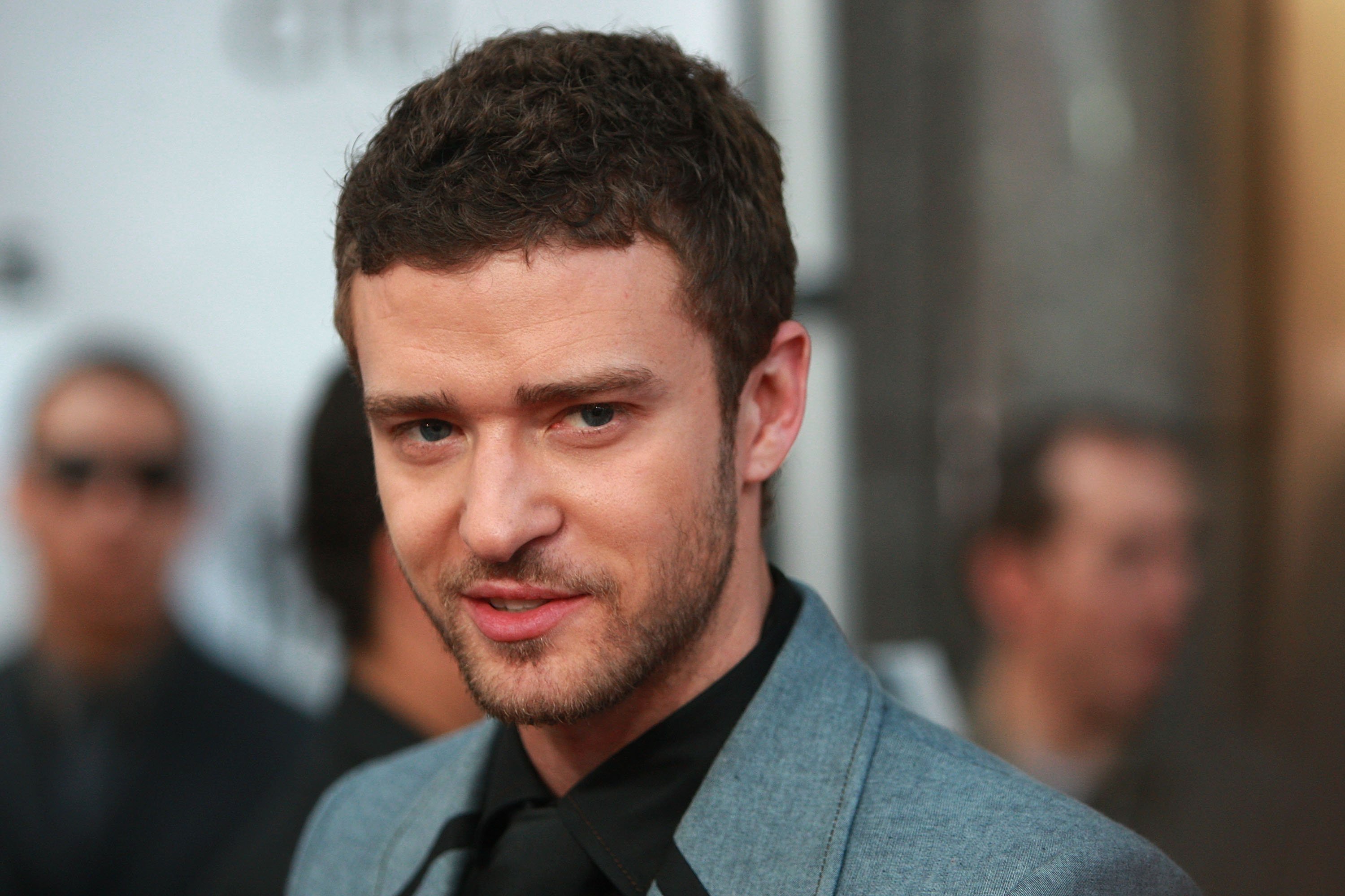 Justin Timberlake smiles for a photo while attending a fashion show