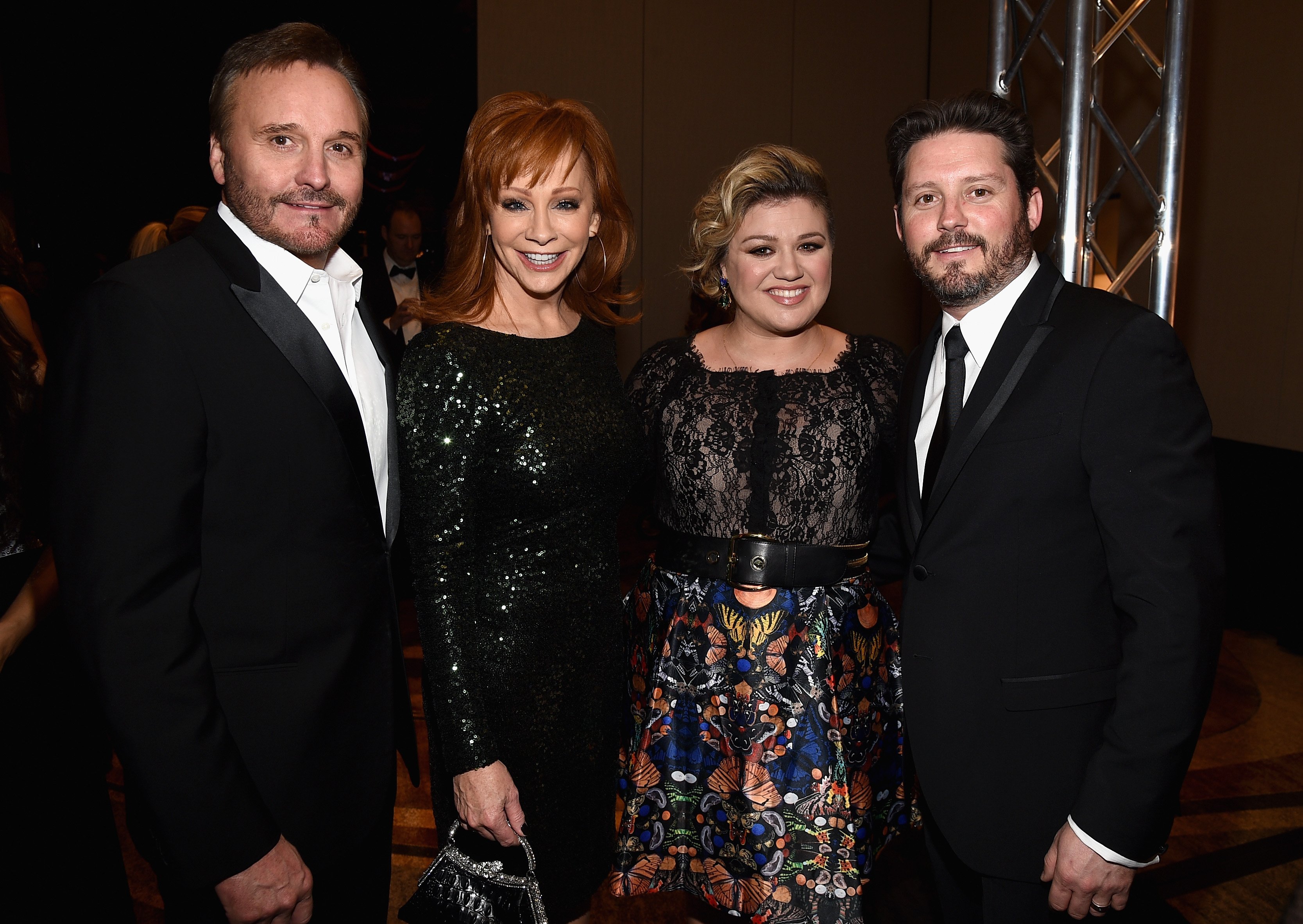 Narvel Blackstock, Reba McEntire, Kelly Clarkson and Brandon Blackstock attend Muhammad Ali's Celebrity Fight Night XXI at the JW Marriott Phoenix Desert Ridge Resort & Spa