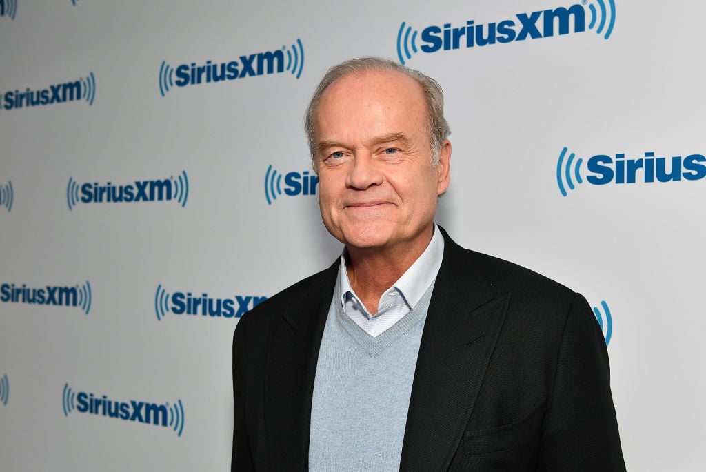 Kelsey Grammer smiling in front of a white background