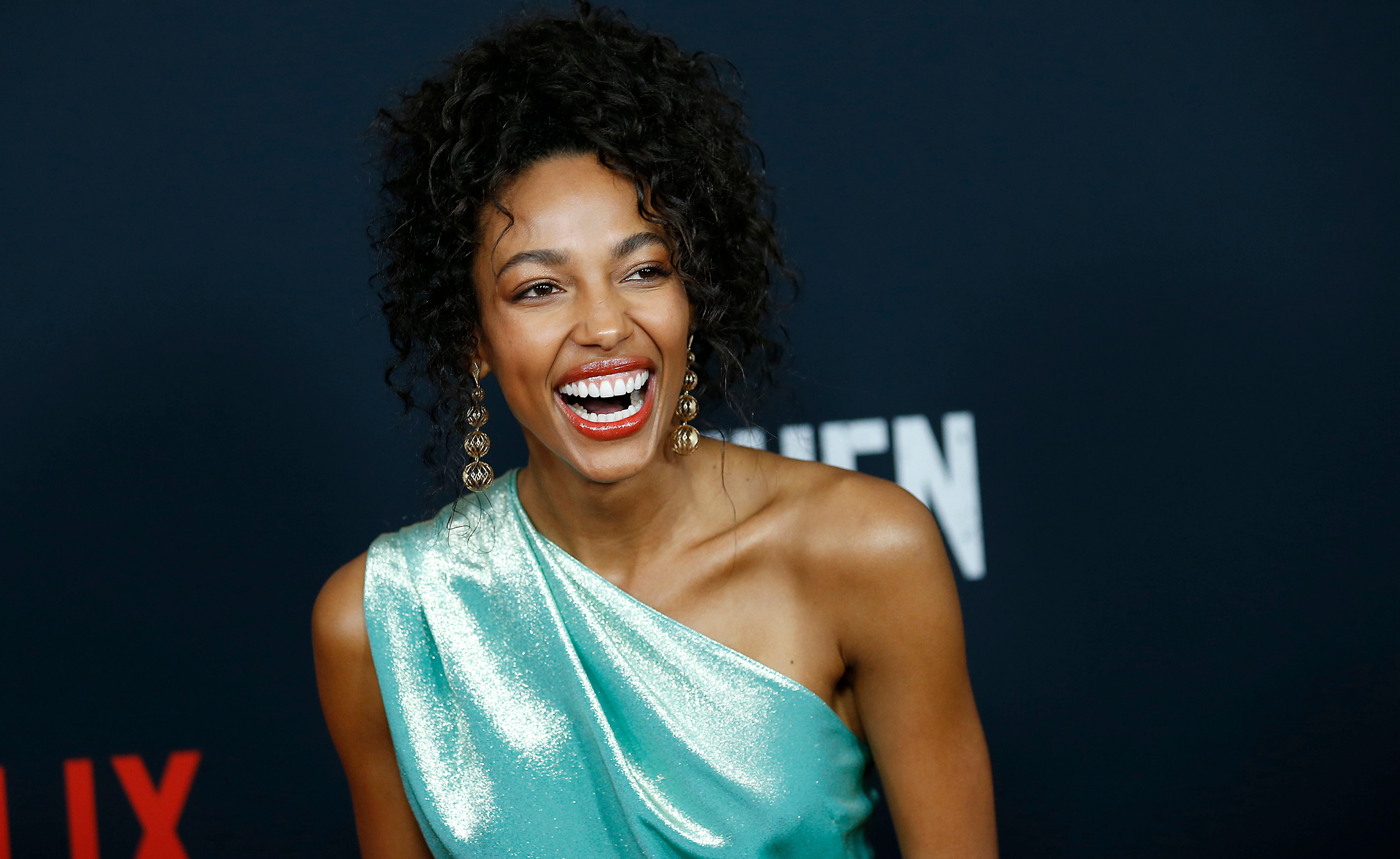 Kylie Bunbury smiles for a photo on the red carpet