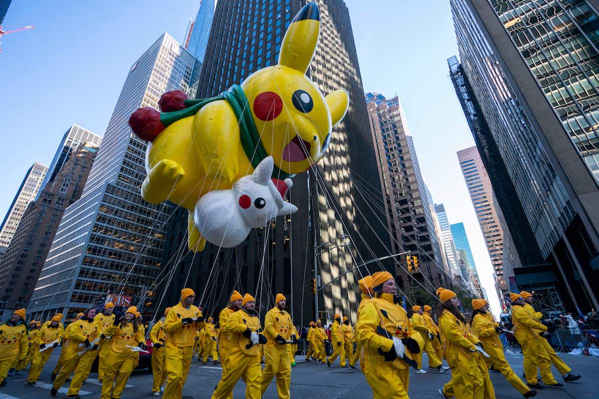 Pikachu (top) and Snow Pikachu fly over 6th Avenue during the 92nd Annual Macy's Thanksgiving Day Parade on November 22, 2018