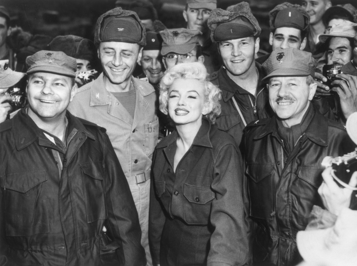 Marilyn Monroe poses for a photo with U.S. soldiers