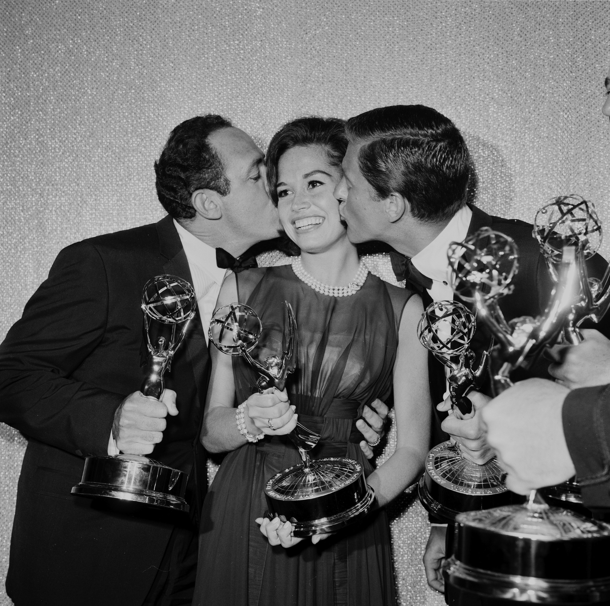Mary Tyler Moore is kissed by co-stars after receiving the Emmy Award for 'The Dick Van Dyke Show'