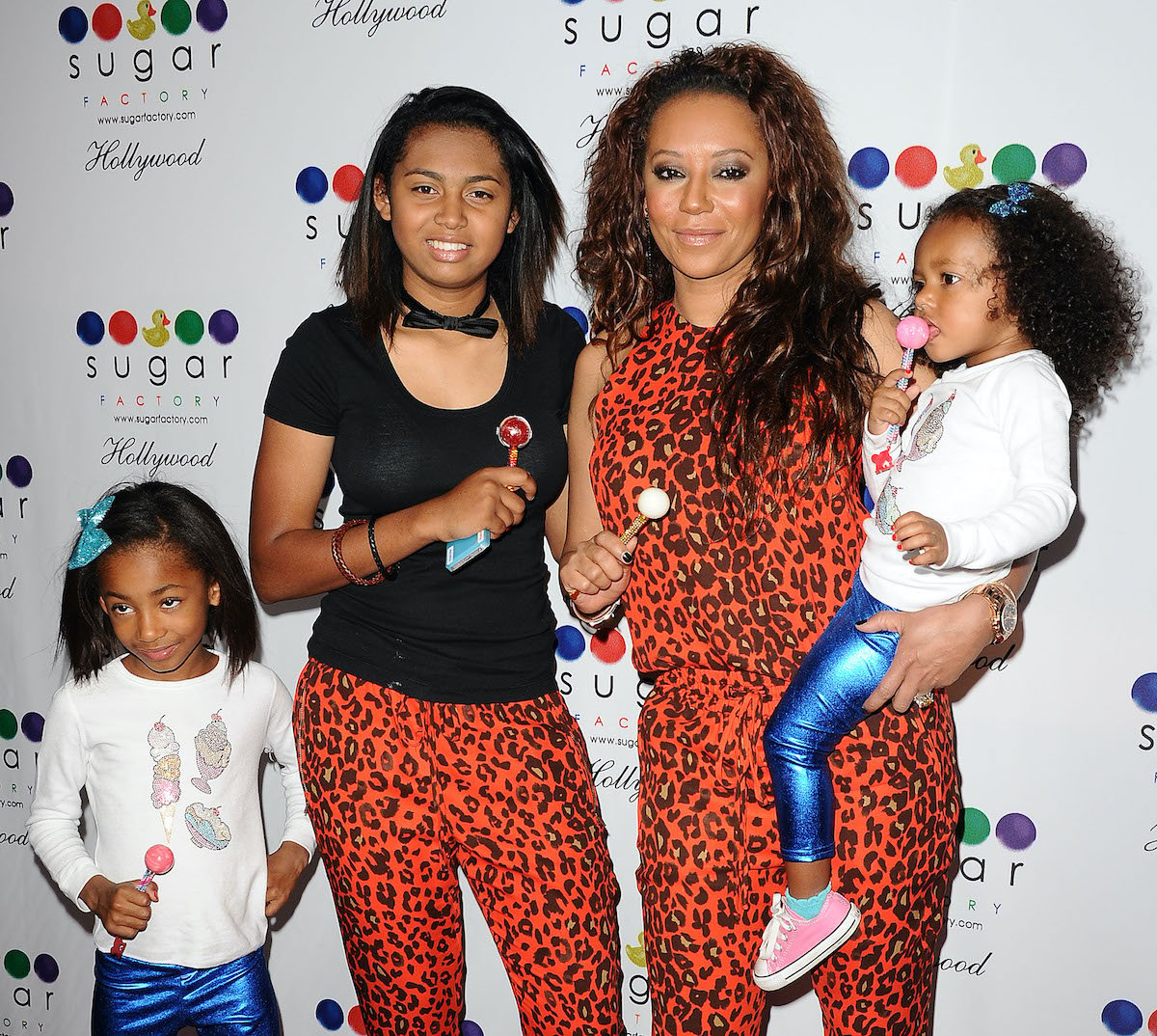 Melanie "Mel B" Brown and her daughters (L-R) Angel Iris Murphy Brown, Phoenix Chi Gulzar and Madison Brown Belafonte attend the grand opening of Sugar Factory Hollywood on November 13, 2013 in Hollywood, Californi