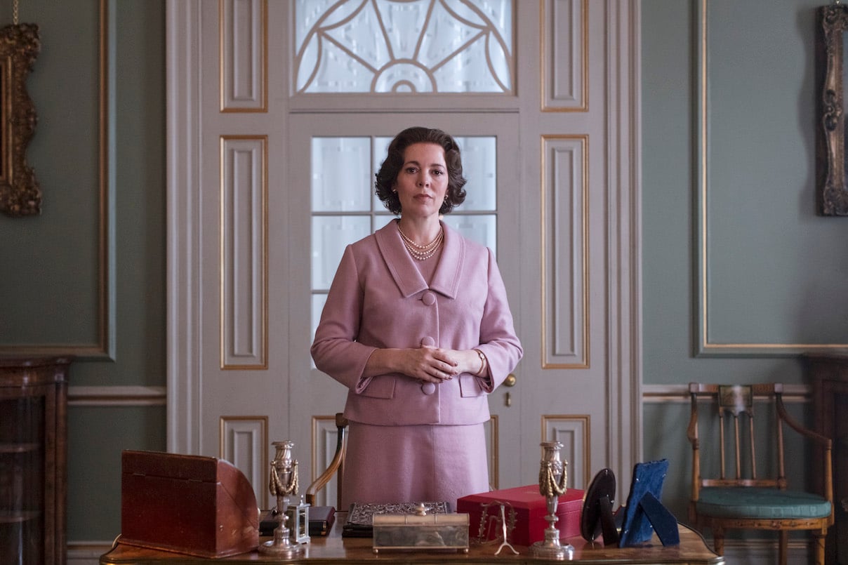 Olivia Colman stands behind a desk as Queen Elizabeth II in 'The Crown' Season 3