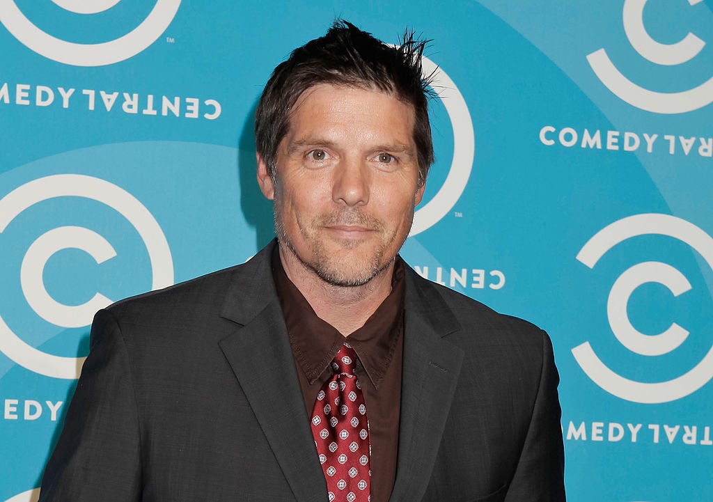 Paul Johansson smiling in front of a blue background