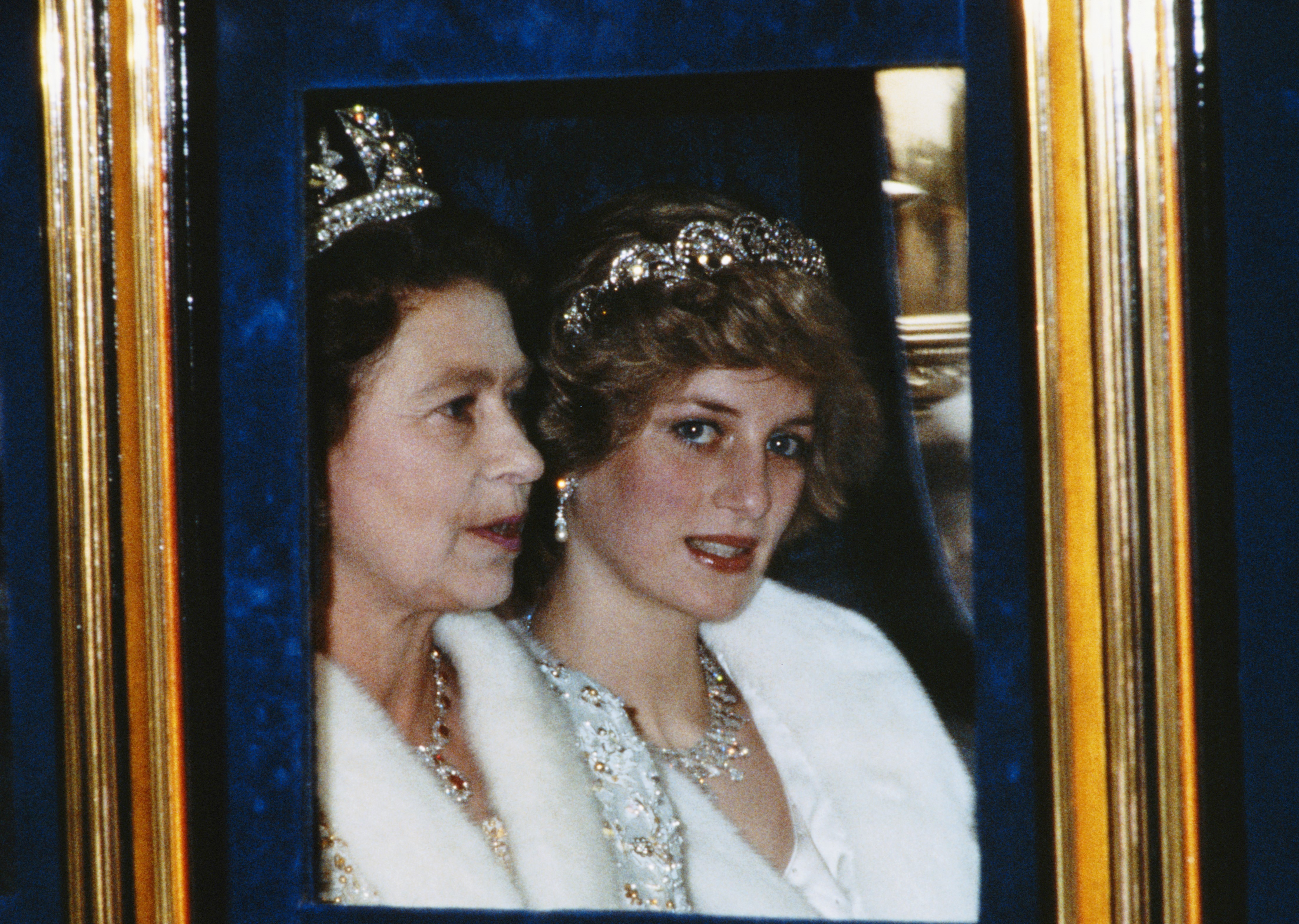 Queen Elizabeth II and Princess Diana riding in a carriage