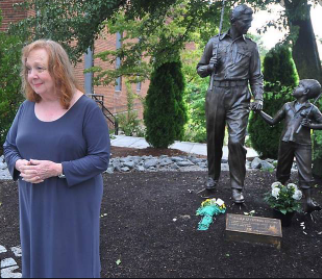 Betty Lynn standing by statue of 'The Andy Griffith Show' characters Sheriff Andy Taylor and his son Opie in her adopted hometown of Mount Airy, North Carolina
