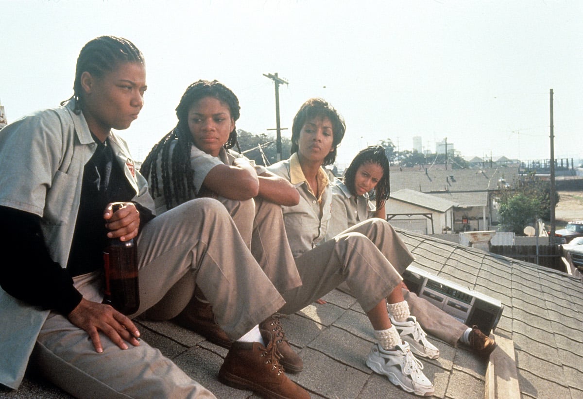 Queen Latifah, Kimberly Elise, Vivica Fox and Jada Pinkett all sitting on the roof of a house in a scene from the film 'Set It Off', 1996 