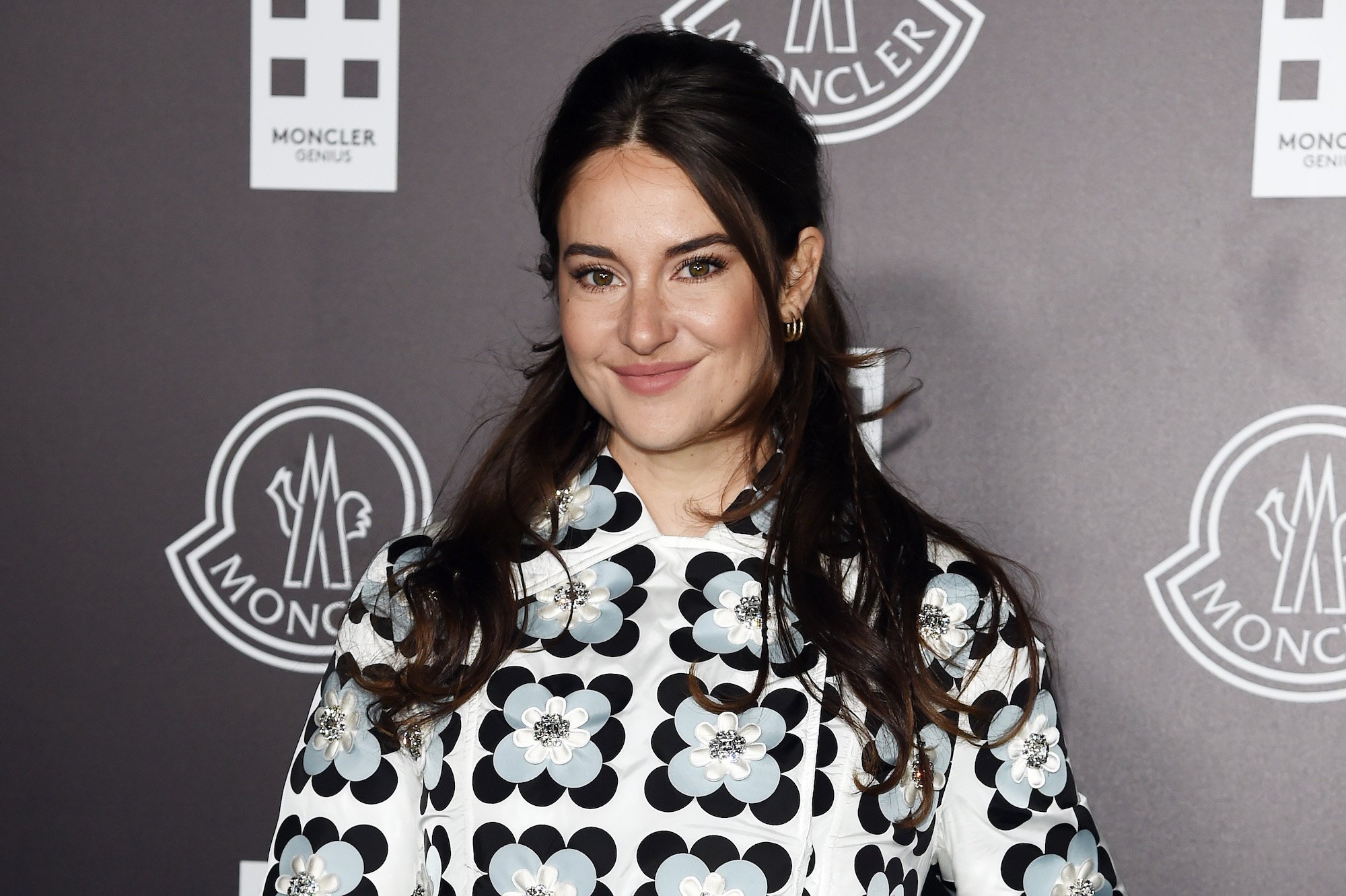 Shailene Woodley smiling in front of a black background