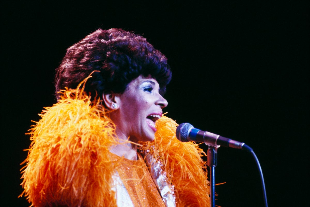 Welsh singer Shirley Bassey performs live on stage in November 1976 | David Redfern/Redferns