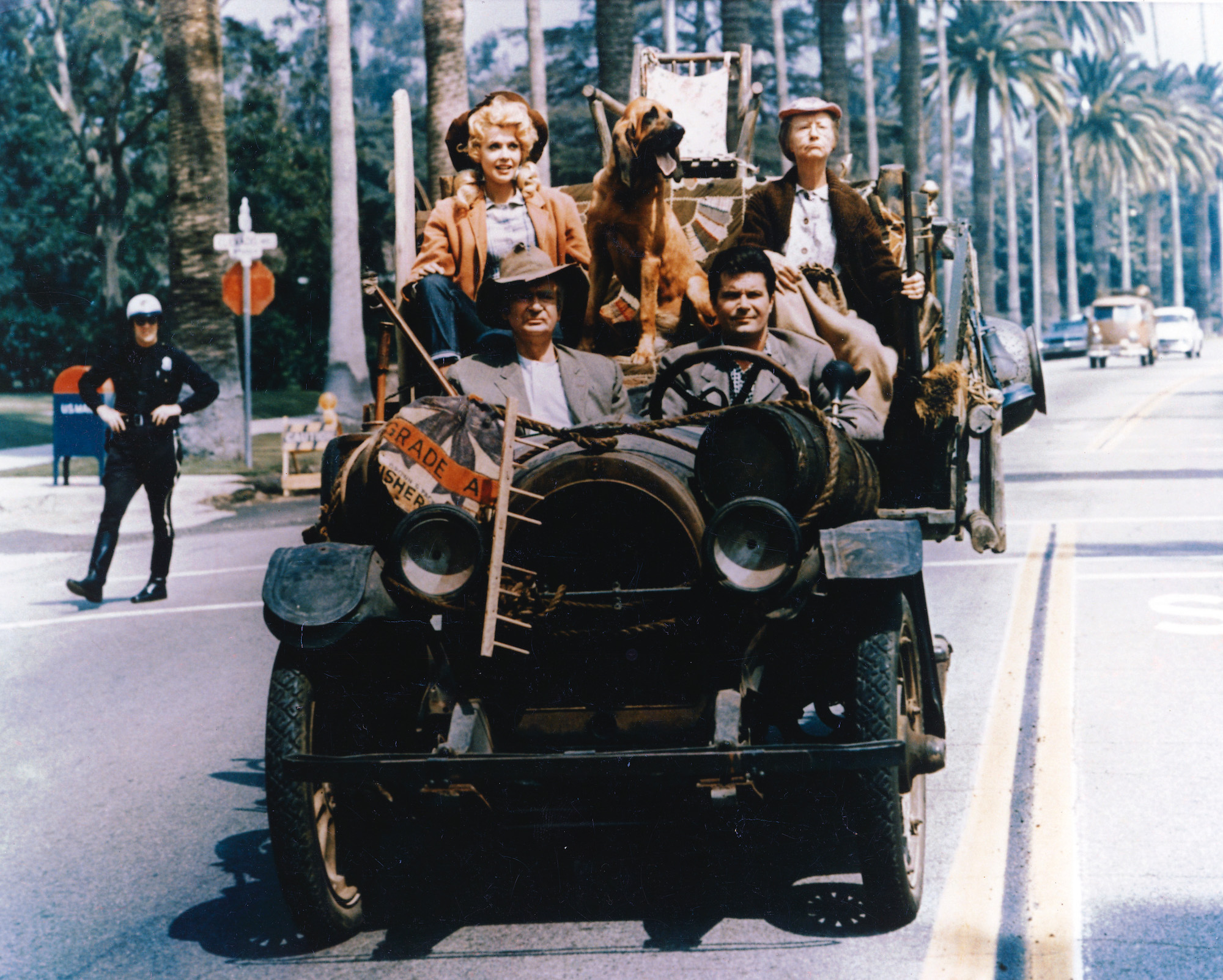 (L-R) Donna Douglas, Irene Ryan, Max Baer Jr, and Buddy Ebsen driving in an old car with no roof