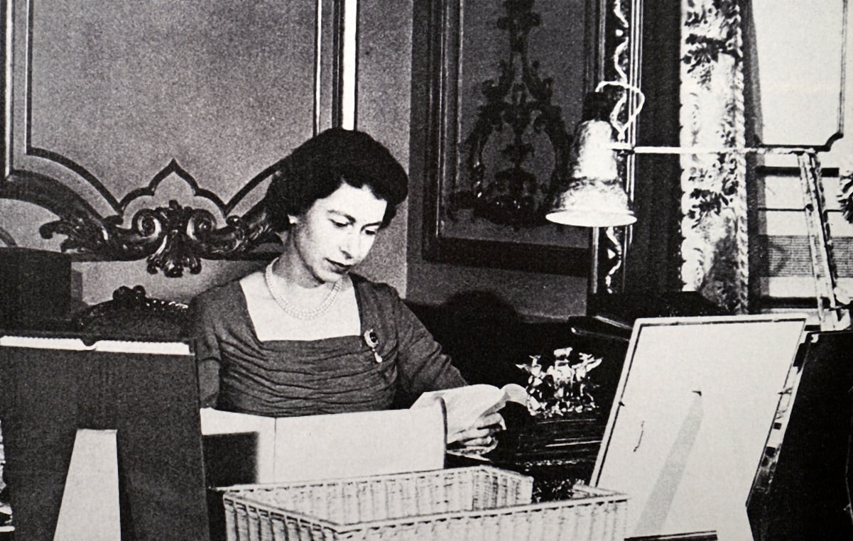 Young Queen Elizabeth II reading a note