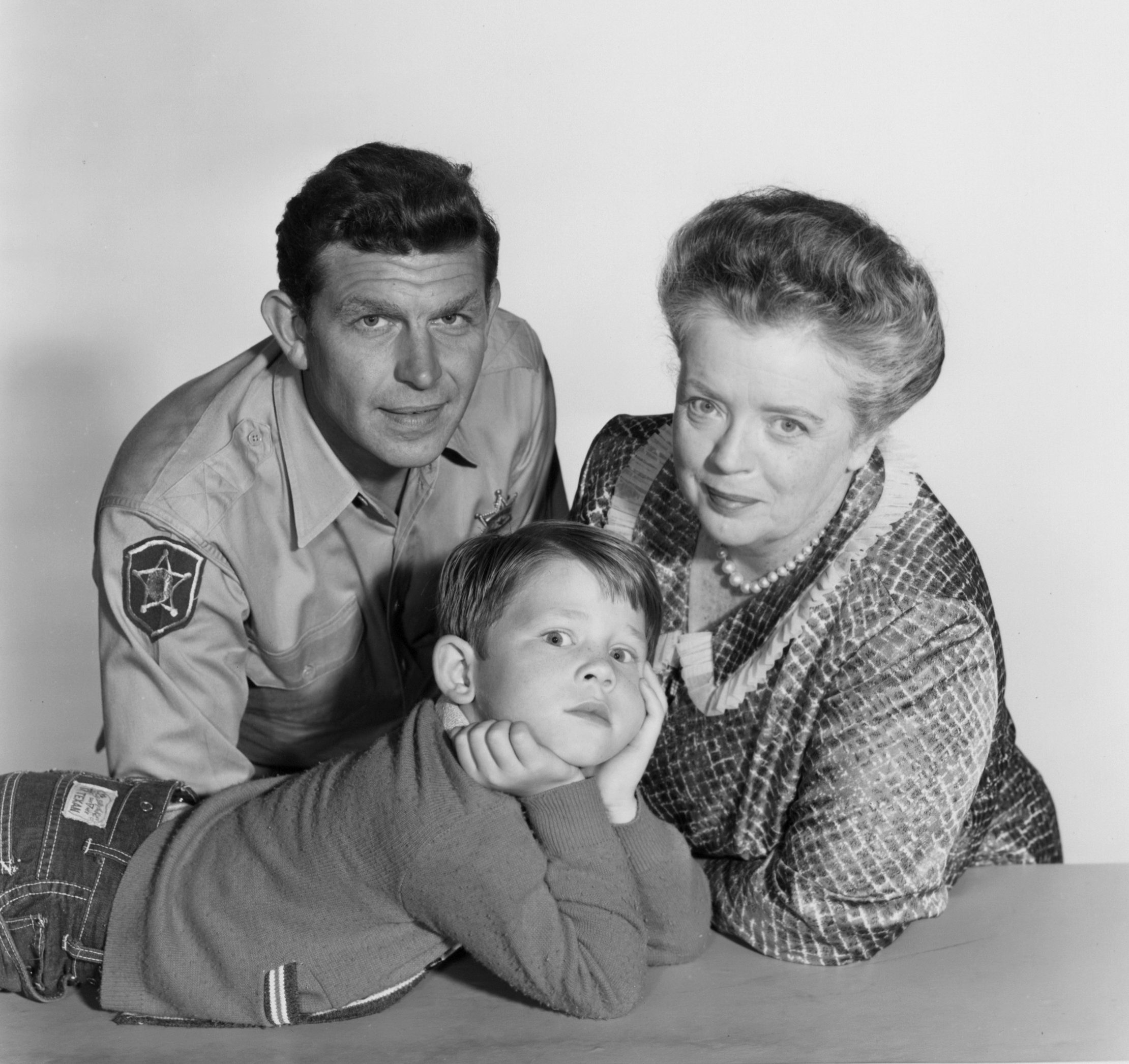 Andy Griffith, Frances Bavier, and Ron Howard looking at the viewer
