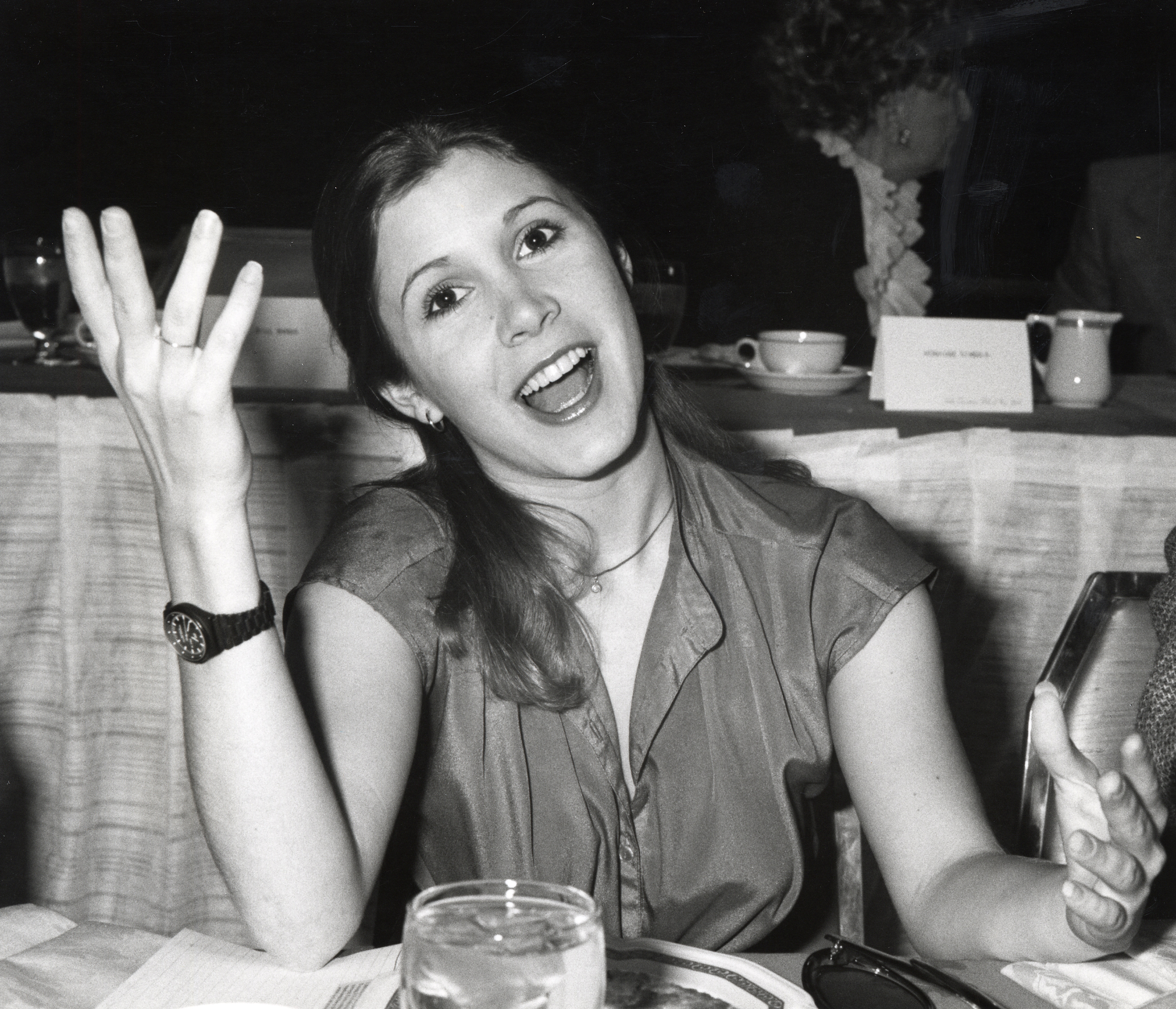 Carrie Fisher with a glass