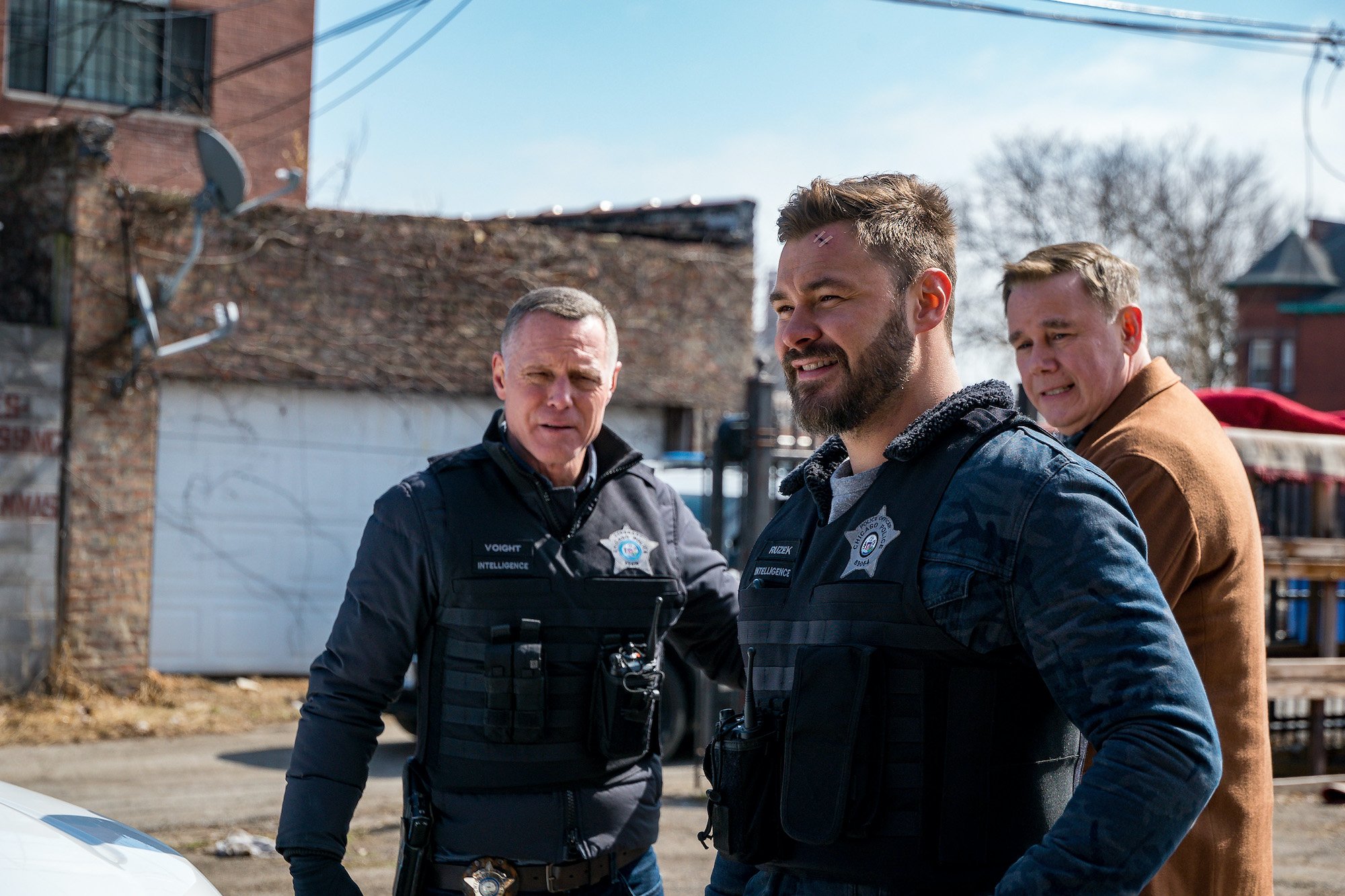 Jason Beghe as Hank Voight, Patrick John Flueger as Adam Ruzek, Spencer Garrett as Wade Henslow