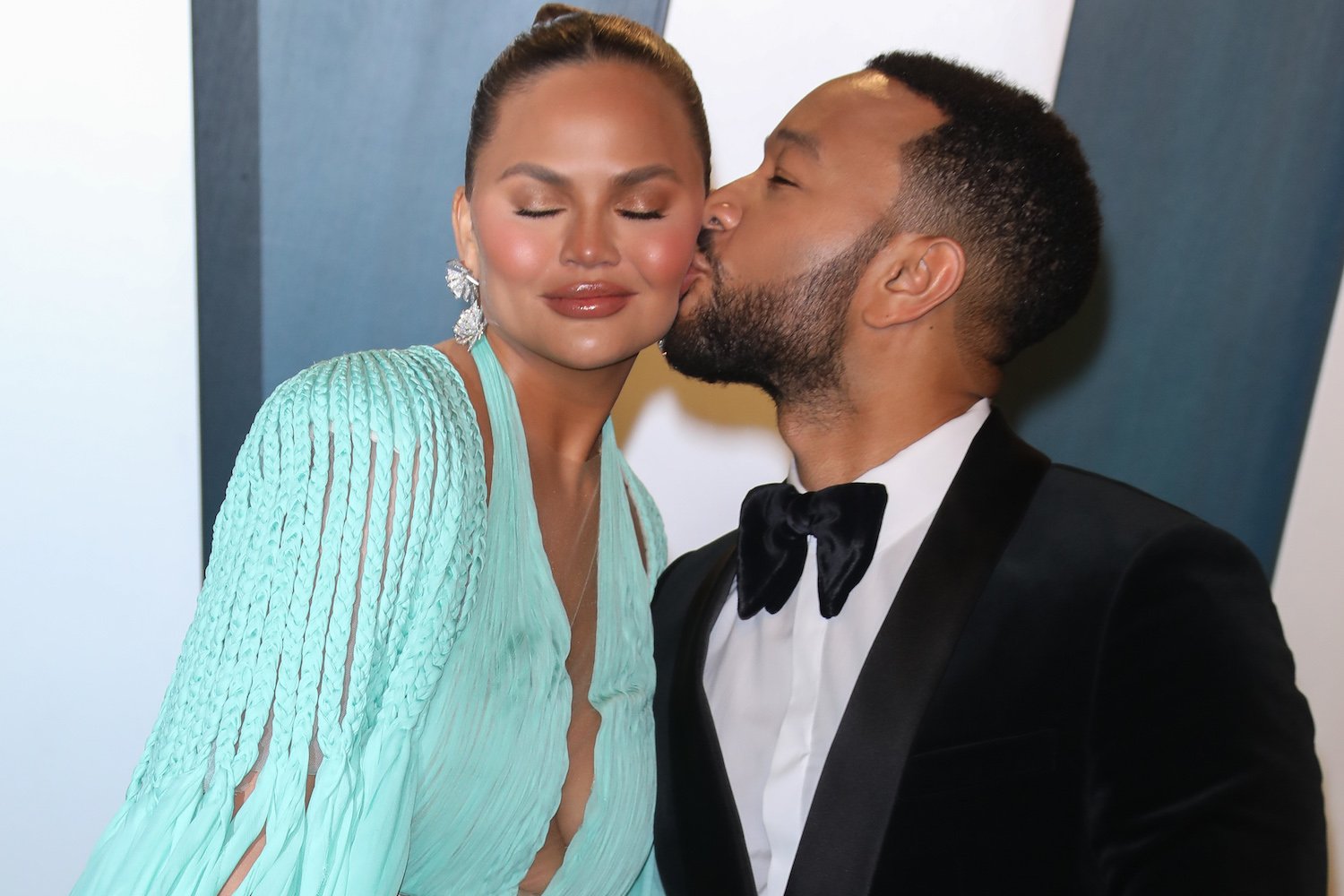 John Legend kisses Chrissy Teigen on cheek 