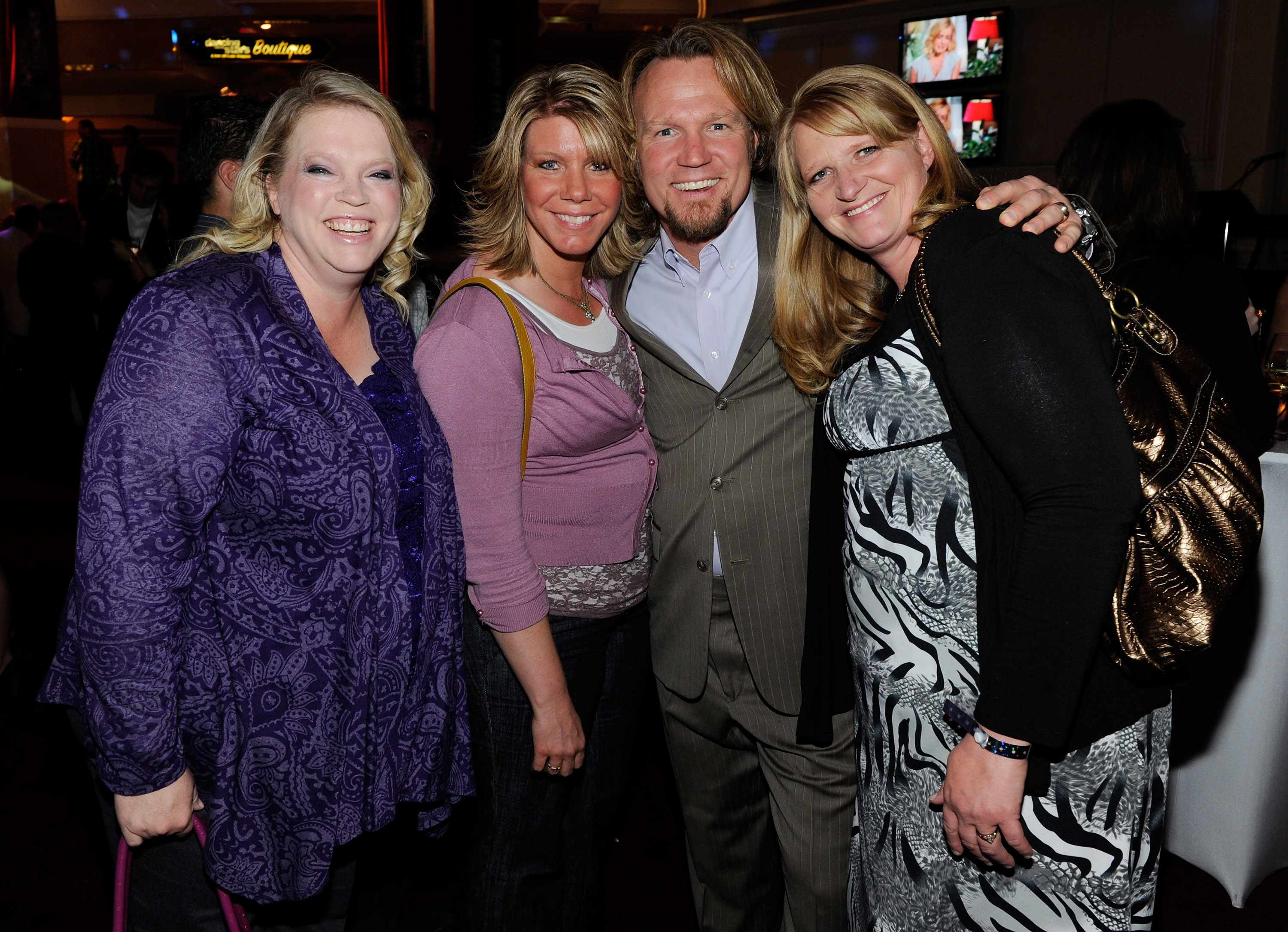 Janelle Brown with her husband and sister wives