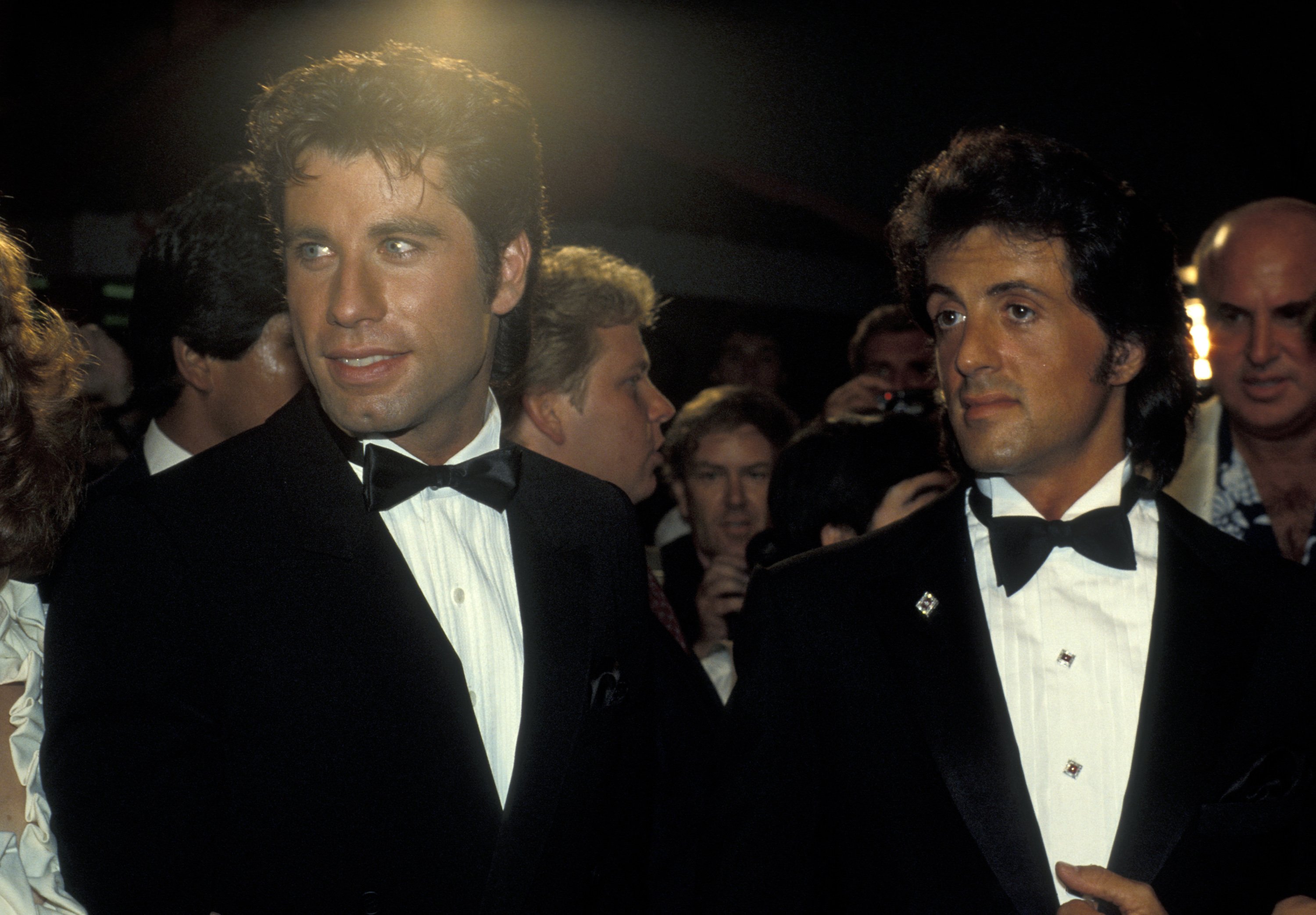 John Travolta and Sylvester Stallone in suits