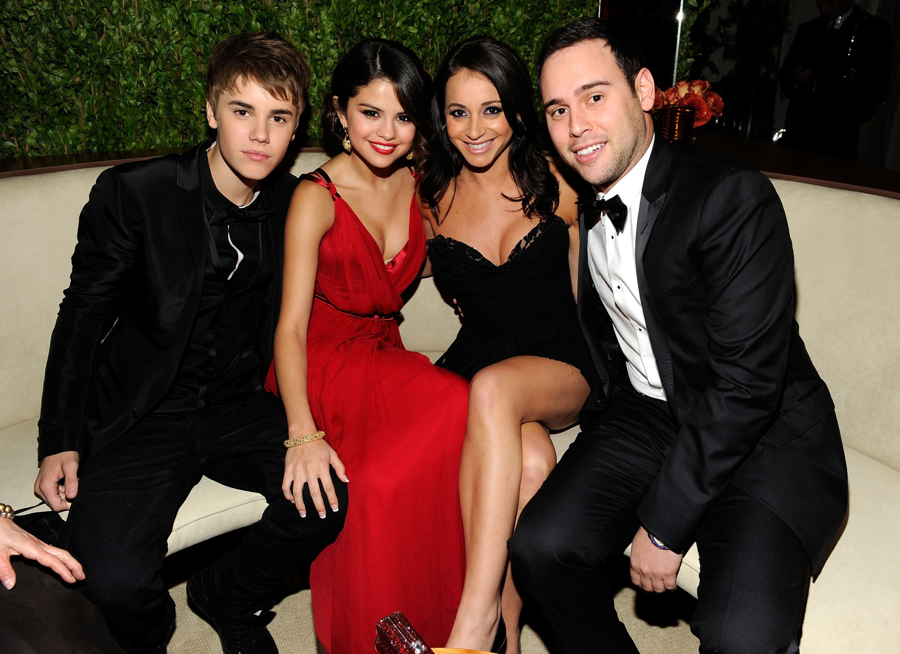 Justin Bieber, Selena Gomez, guest, and Scooter Braun attend the 2011 Vanity Fair Oscar Party on February 27, 2011, in West Hollywood, California.