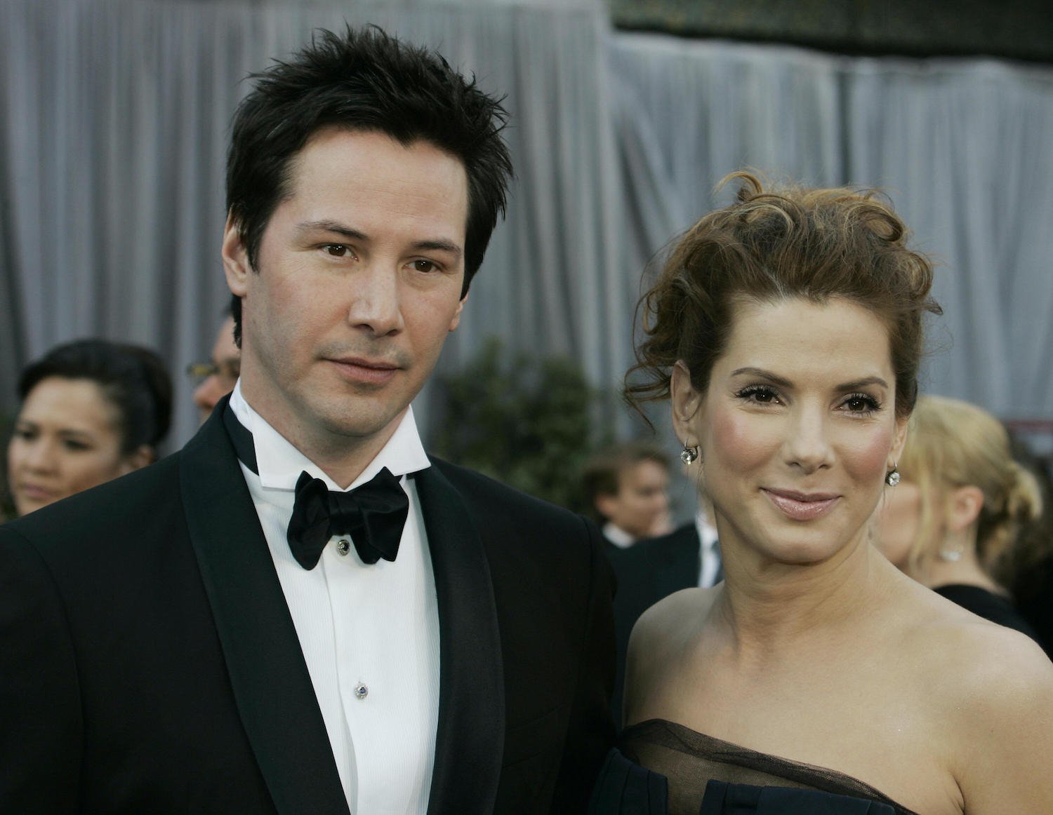 Keanu Reeves and Sandra Bullock arrive for the 78th Academy Awards