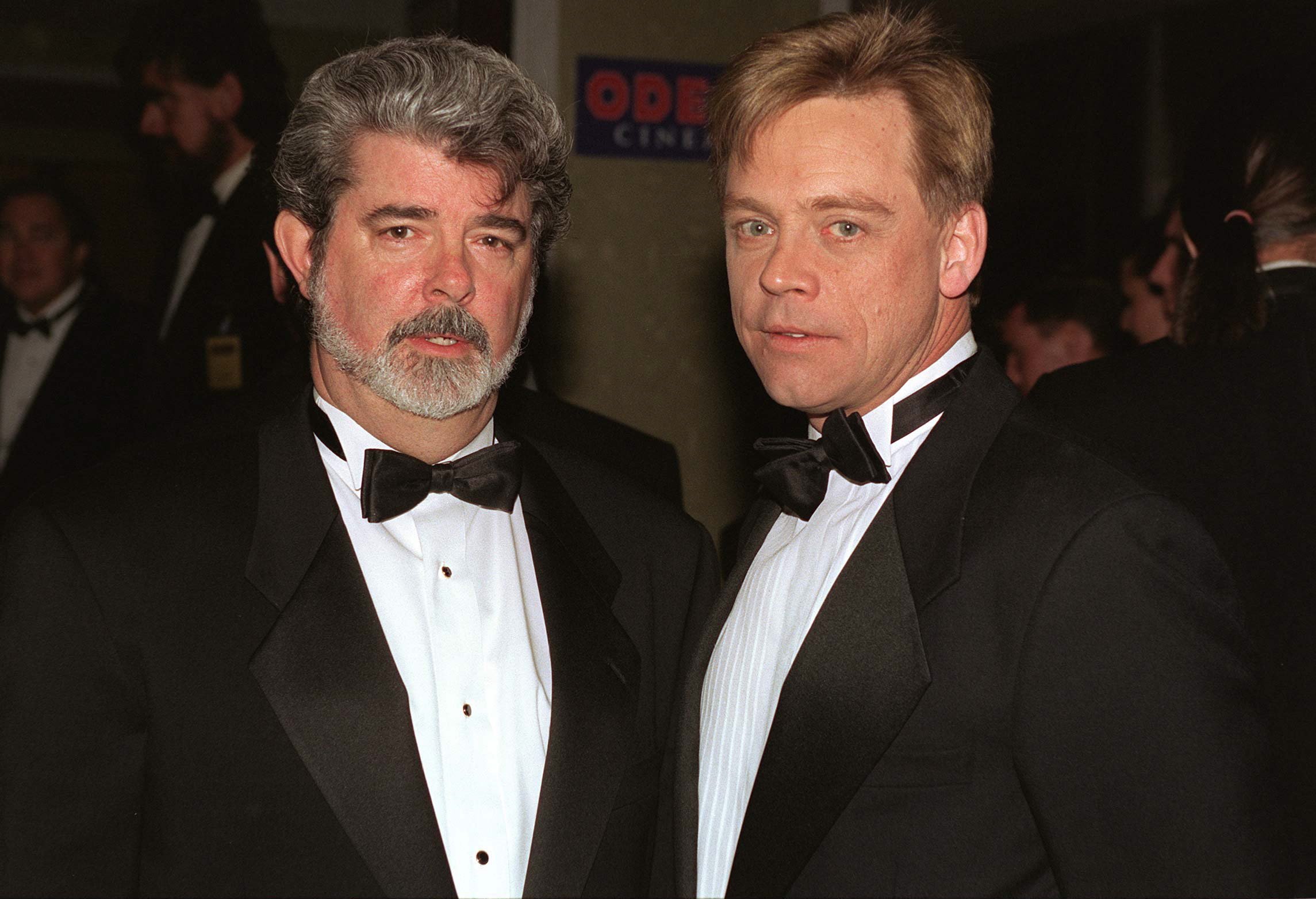 George Lucas and Mark Hamill wearing suits